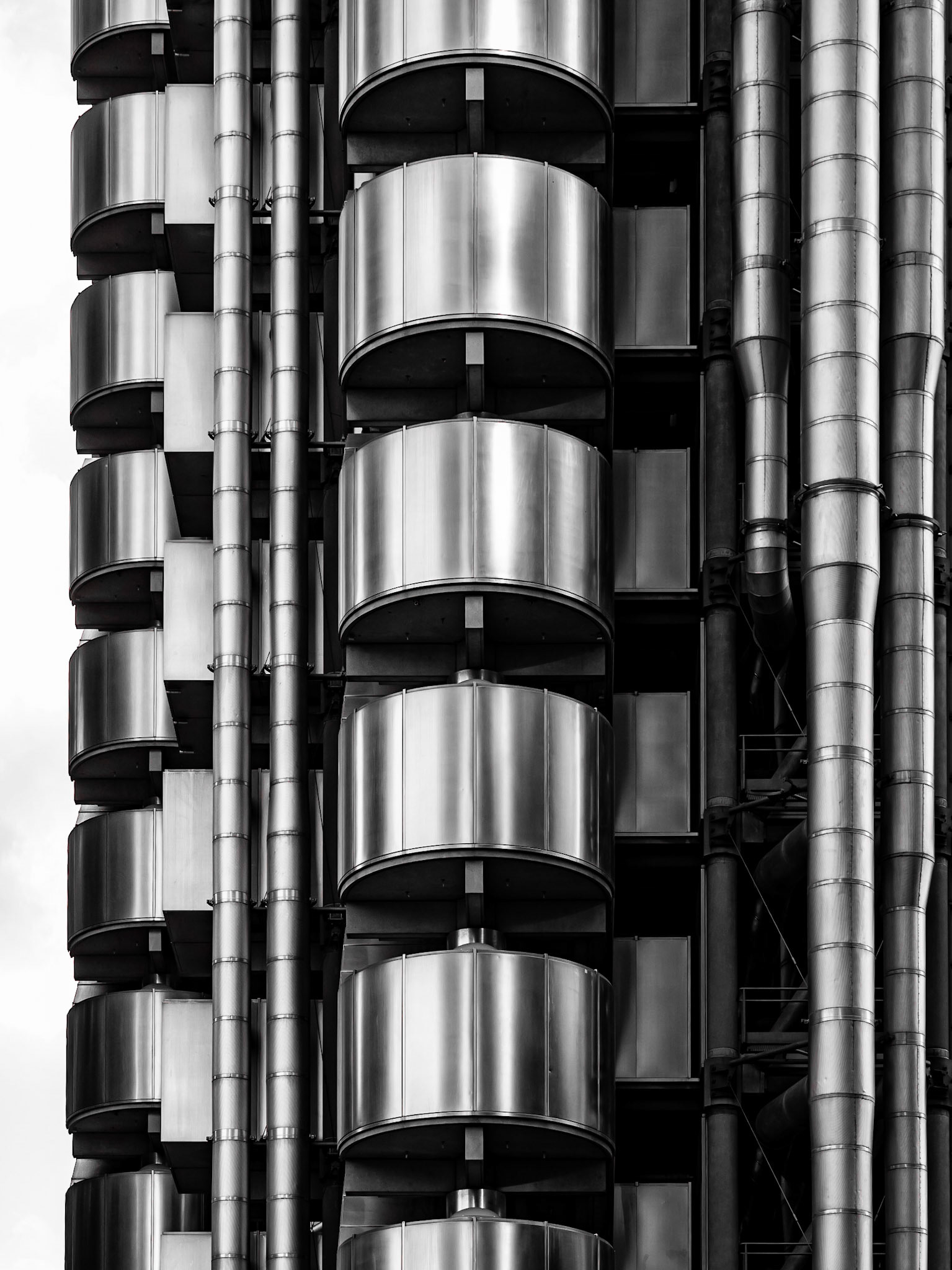 Stairwells jut out of the shiny steel exterior of the modern Lloyds Building in the City of London