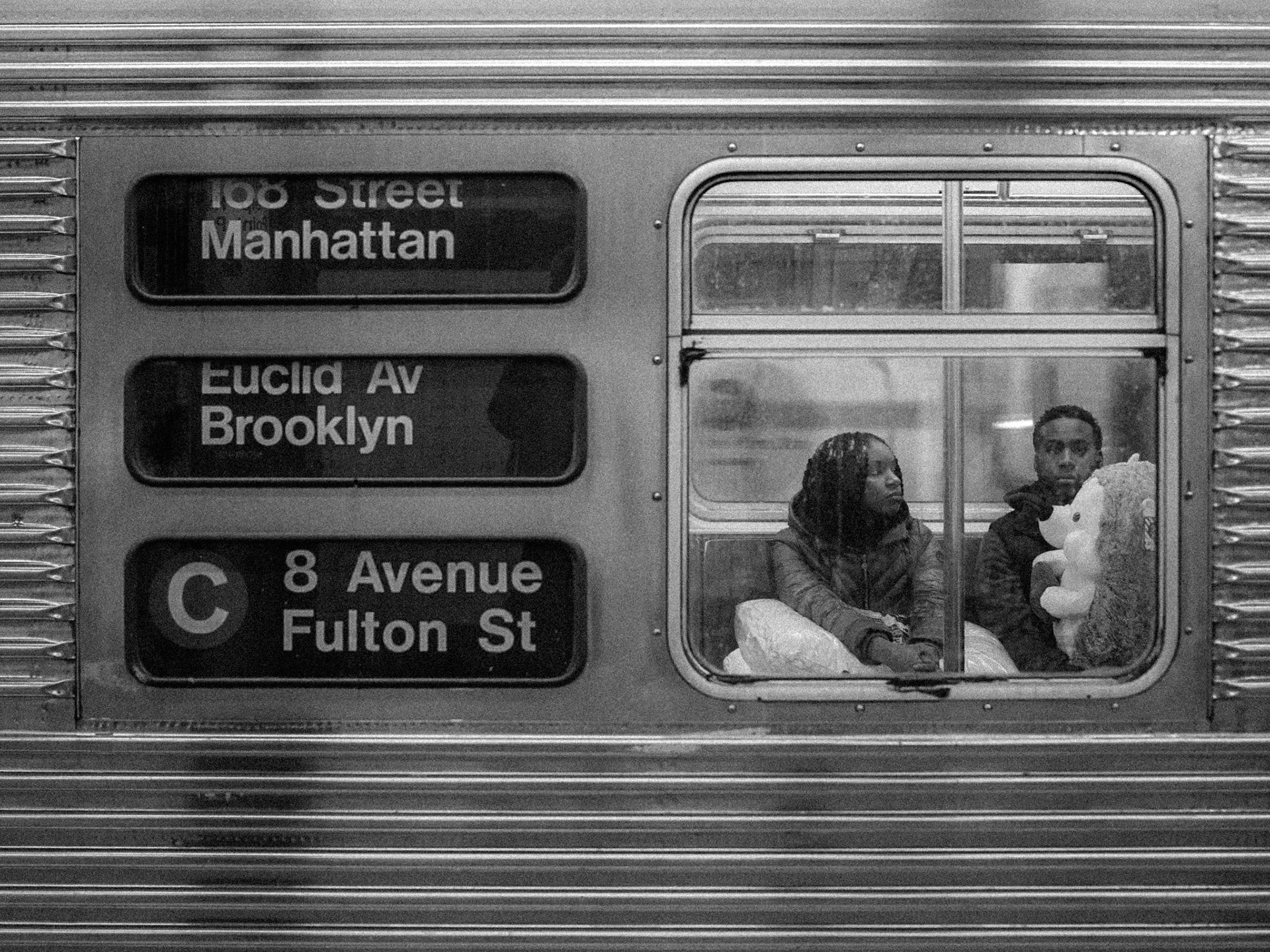 A father sits with his gift for his daughter on a subway train at 168th St station in Manhattan, New York