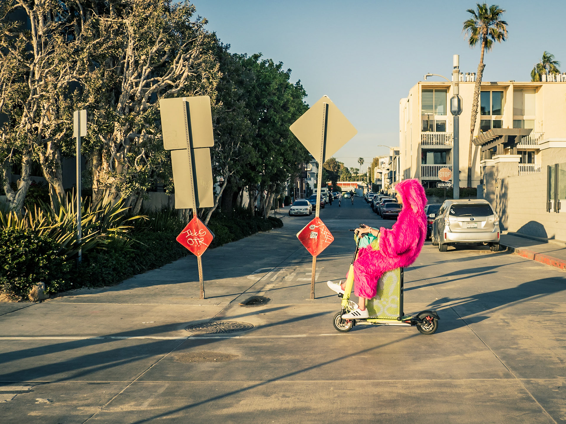 A local resident rides along Venice beachfront resplendent in dazzling pink on a boomtastic scooter