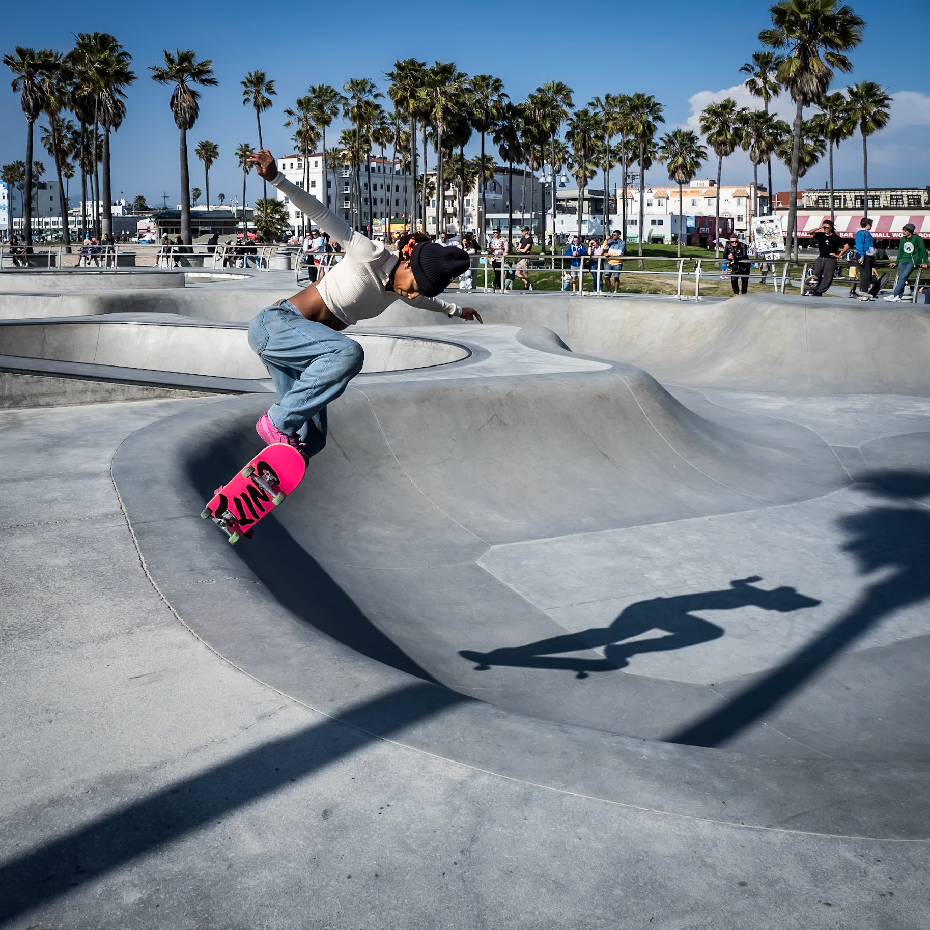 A skateboarder hangs in the air whilst performing a stunt at the skate park in Venice Beach, California