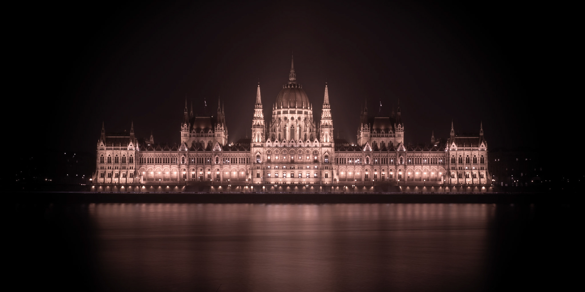 A haunting image of the gothic architecture of the Hungarian Parliament sitting alongside the River Danube