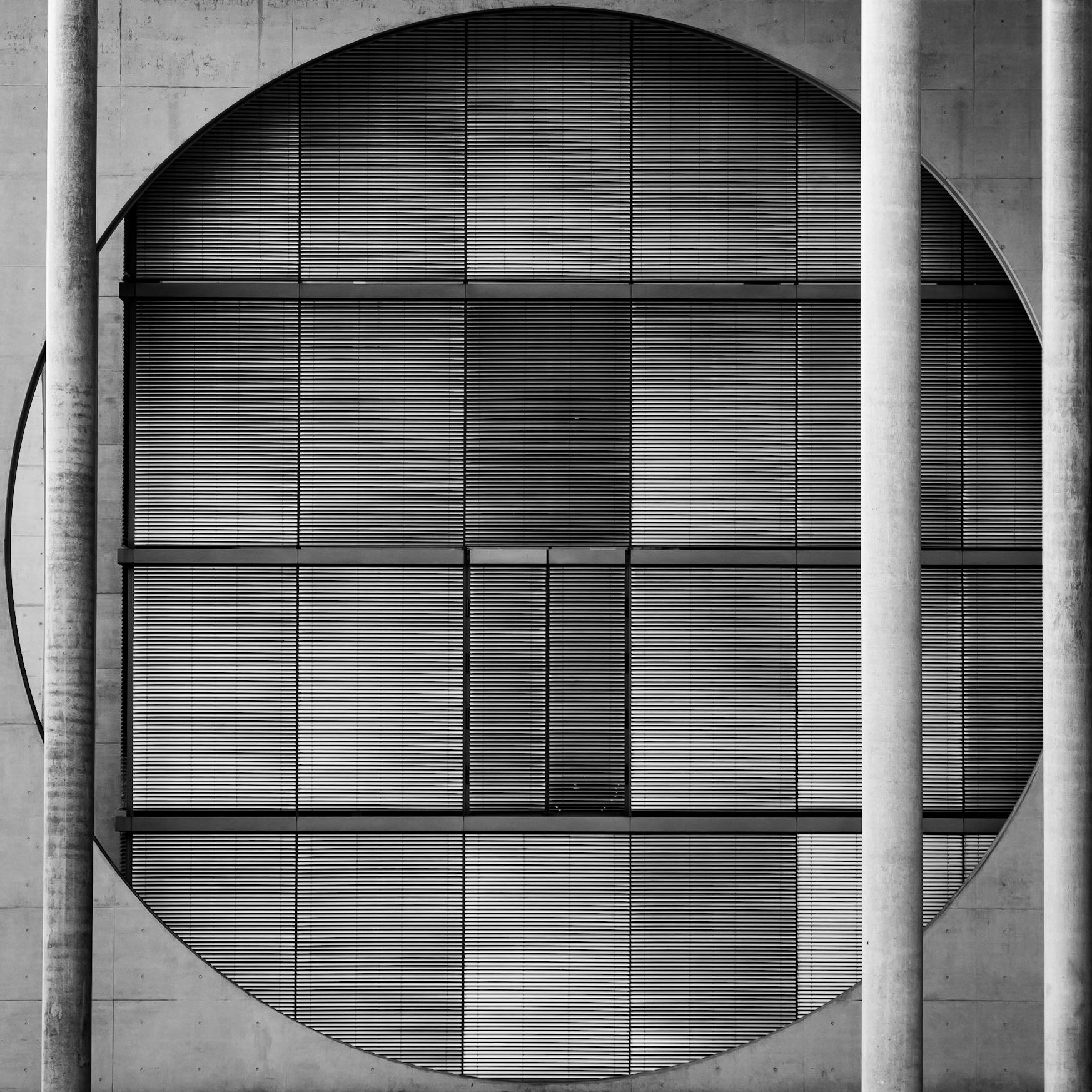 Venetian blinds prevent the bright sunlight from shining through an enormous circular window in the parliamentary district of Berlin