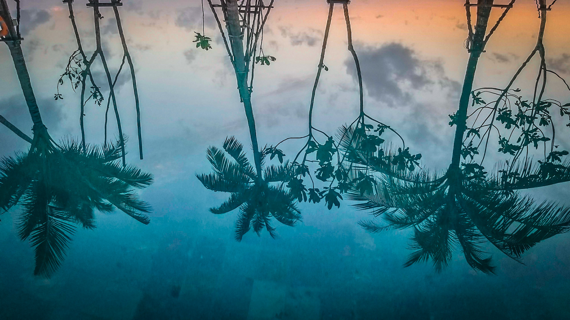 Sunset reflects in the pool at the La Vela hotel in Khao Lak, Thailand