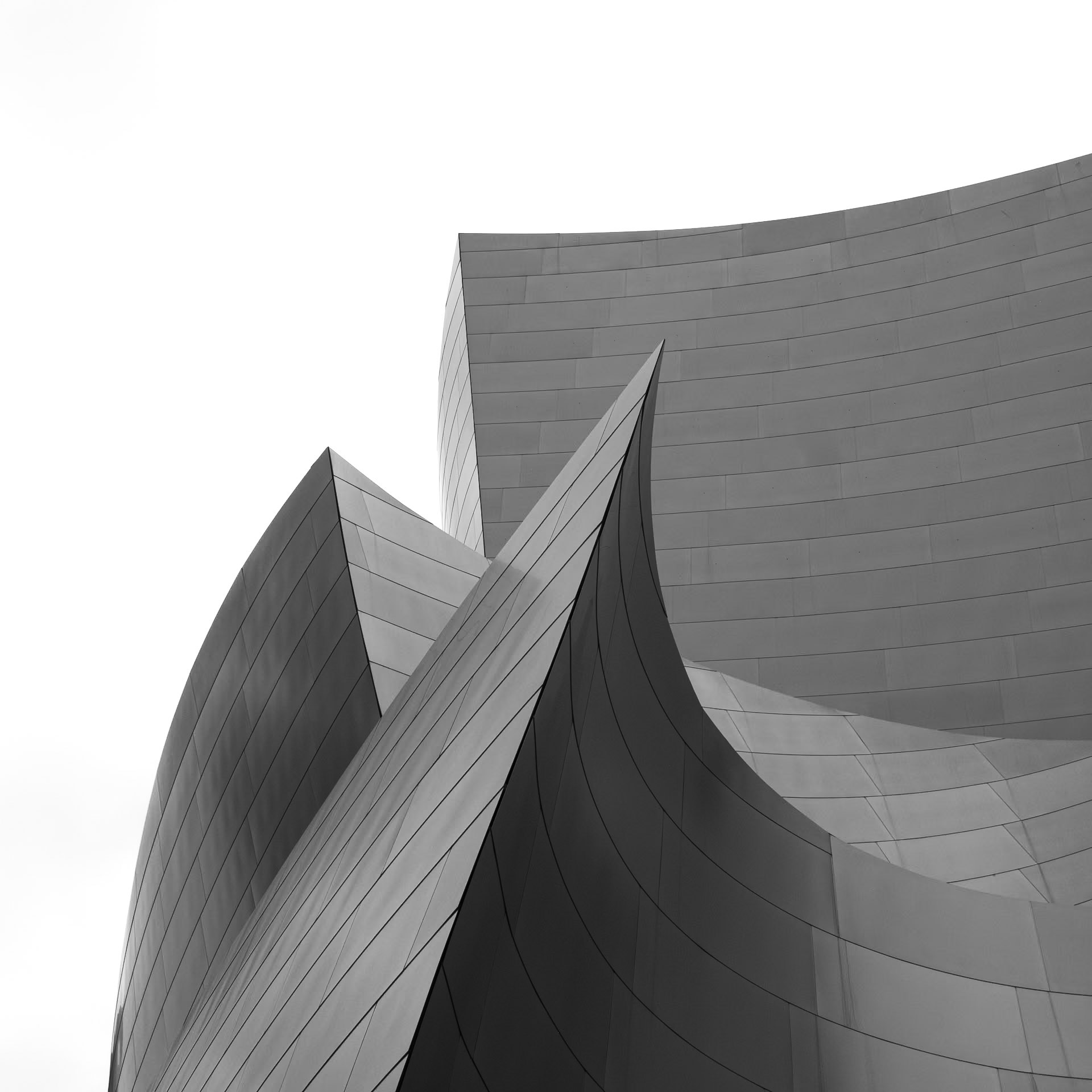 The curves of Walt Disney Music Theatre in downtown Los Angeles jut into the clear sky