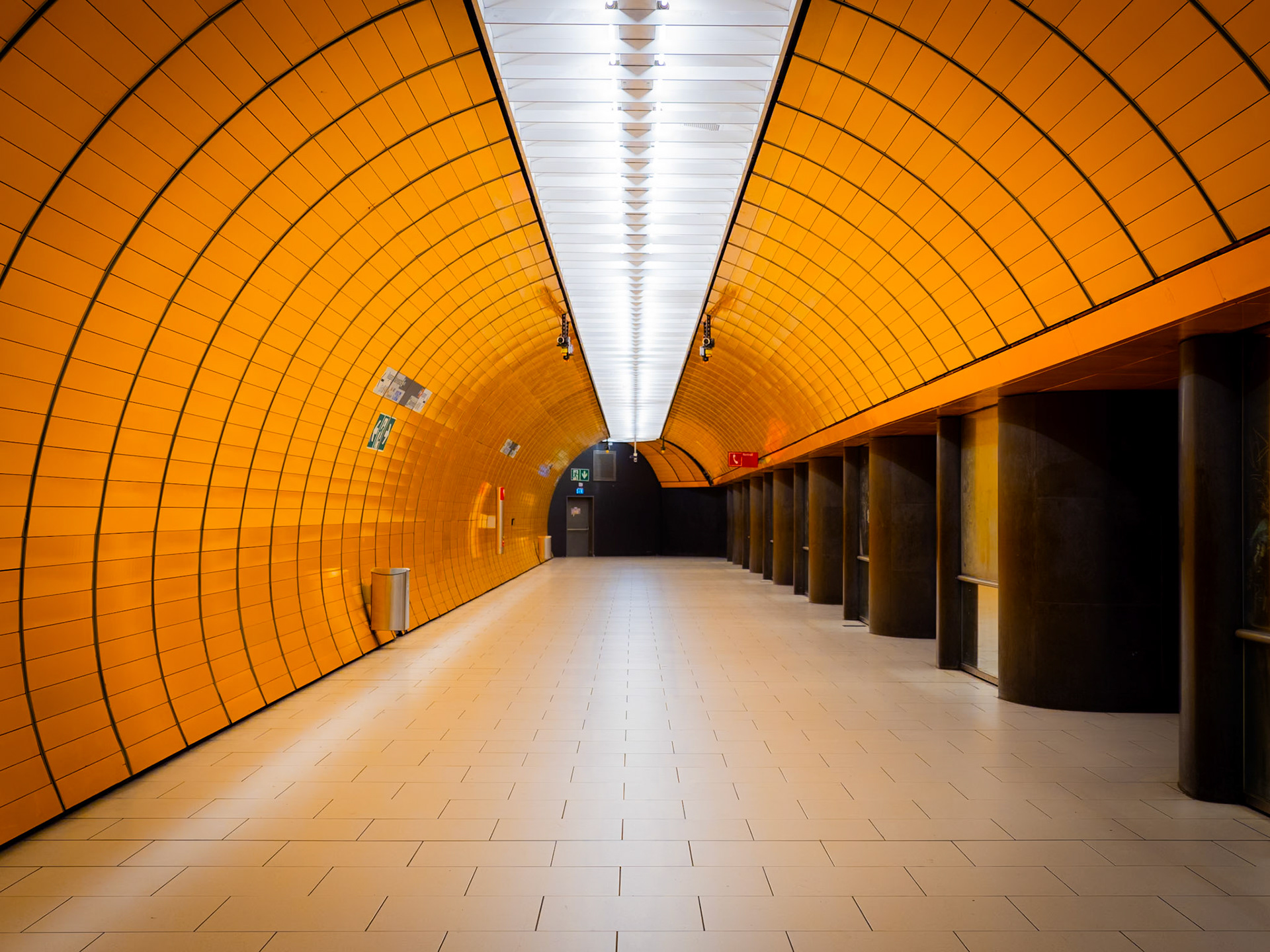 A bright orange passageway in a station on the Munich U-Bahn