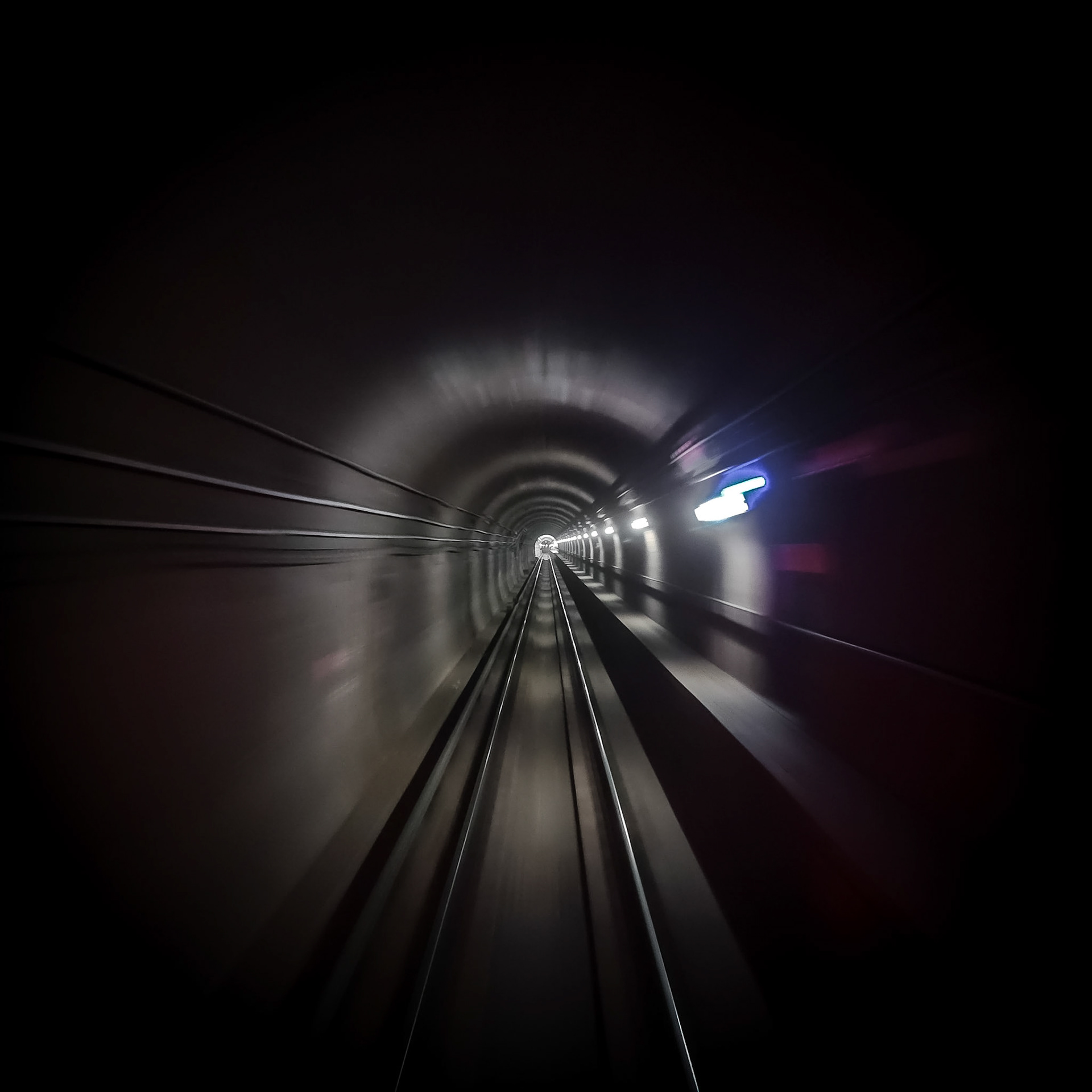 Lights flash by as an underground metro train rushes through a tunnel under the streets of central Chicago