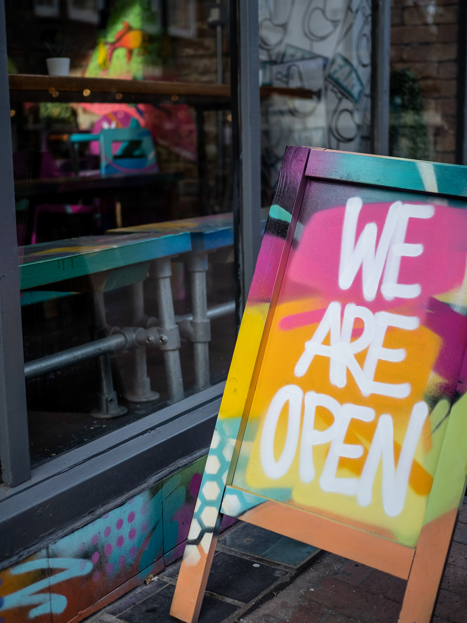 A sign outside a restaurant in the Lanes of Brighton entices potential diners to try their food offerings now outdoor dining is once again permitted