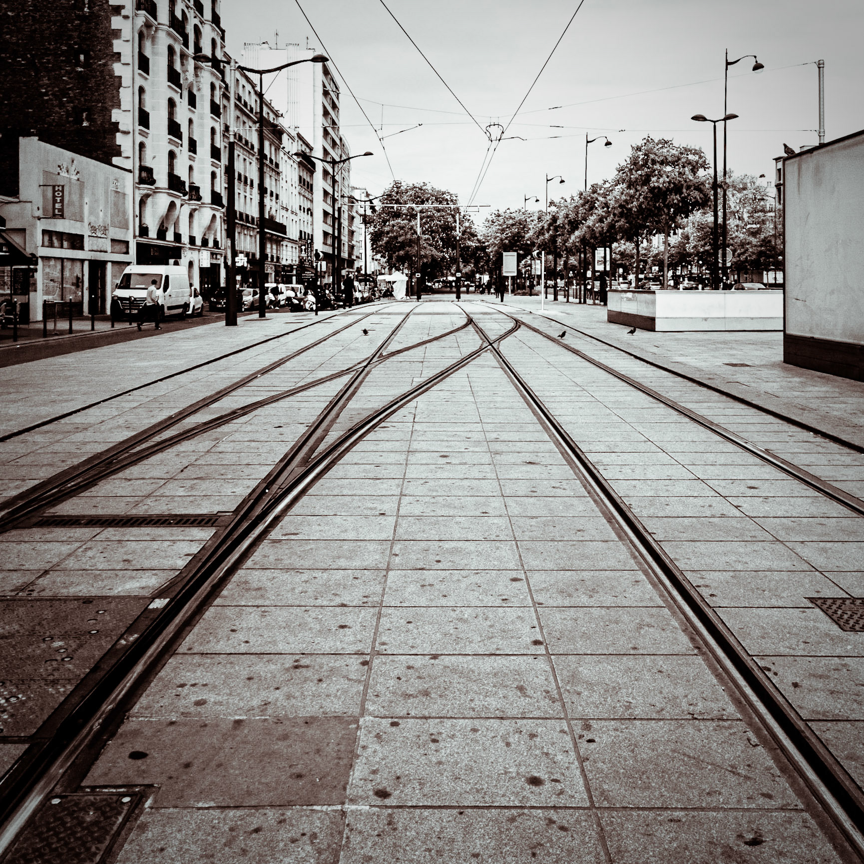 A set of tramlines converge on the street in the Porte de Vincennes district of Paris