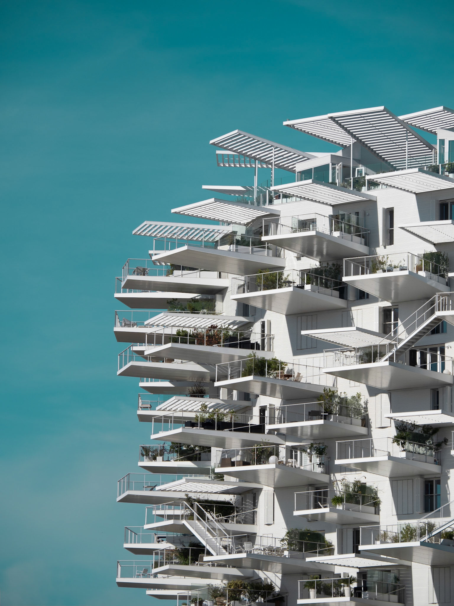 Numerous balconies jut out into the city skyline from a building in Montpellier in southern France