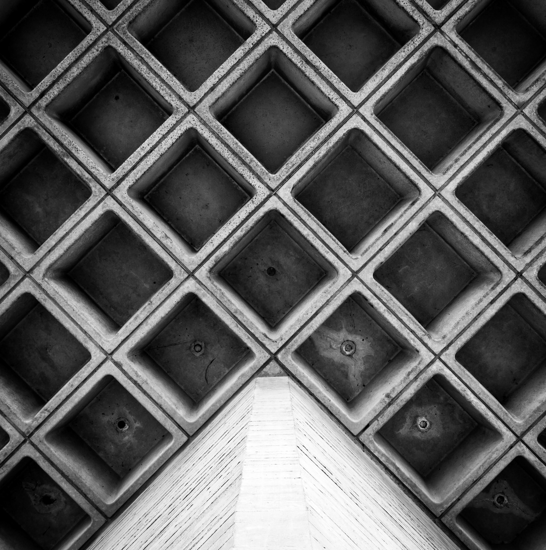 Square blocks criss-cross the underside of a balcony of the National Theatre in London's South Bank Centre