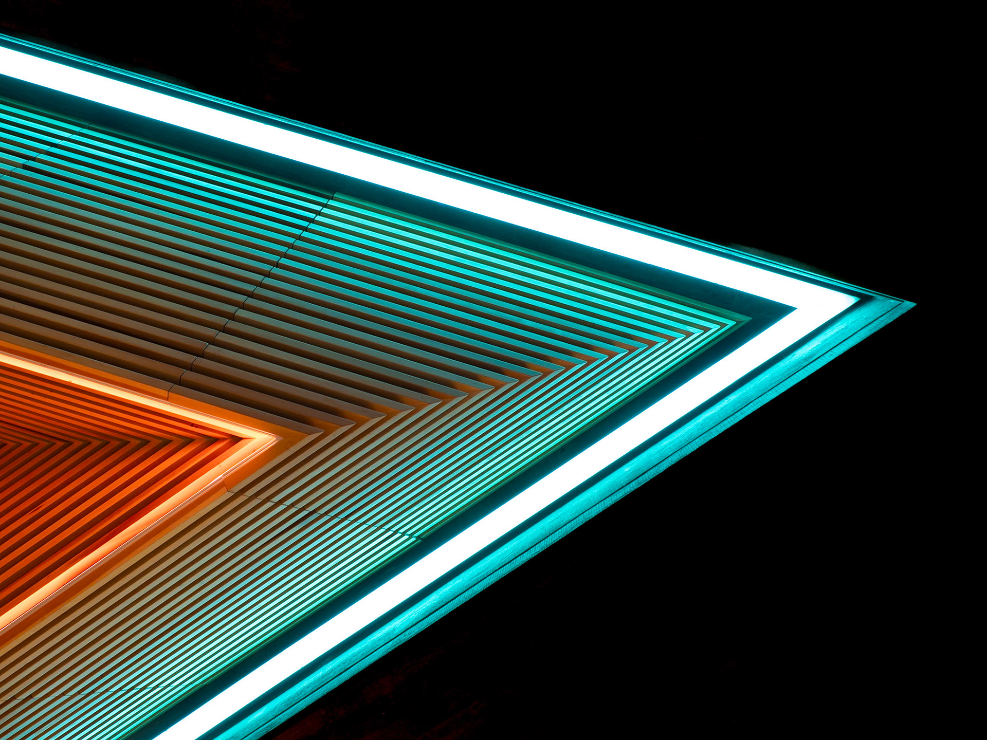 Shades of cyan and orange merge to form a sharp point into darkness