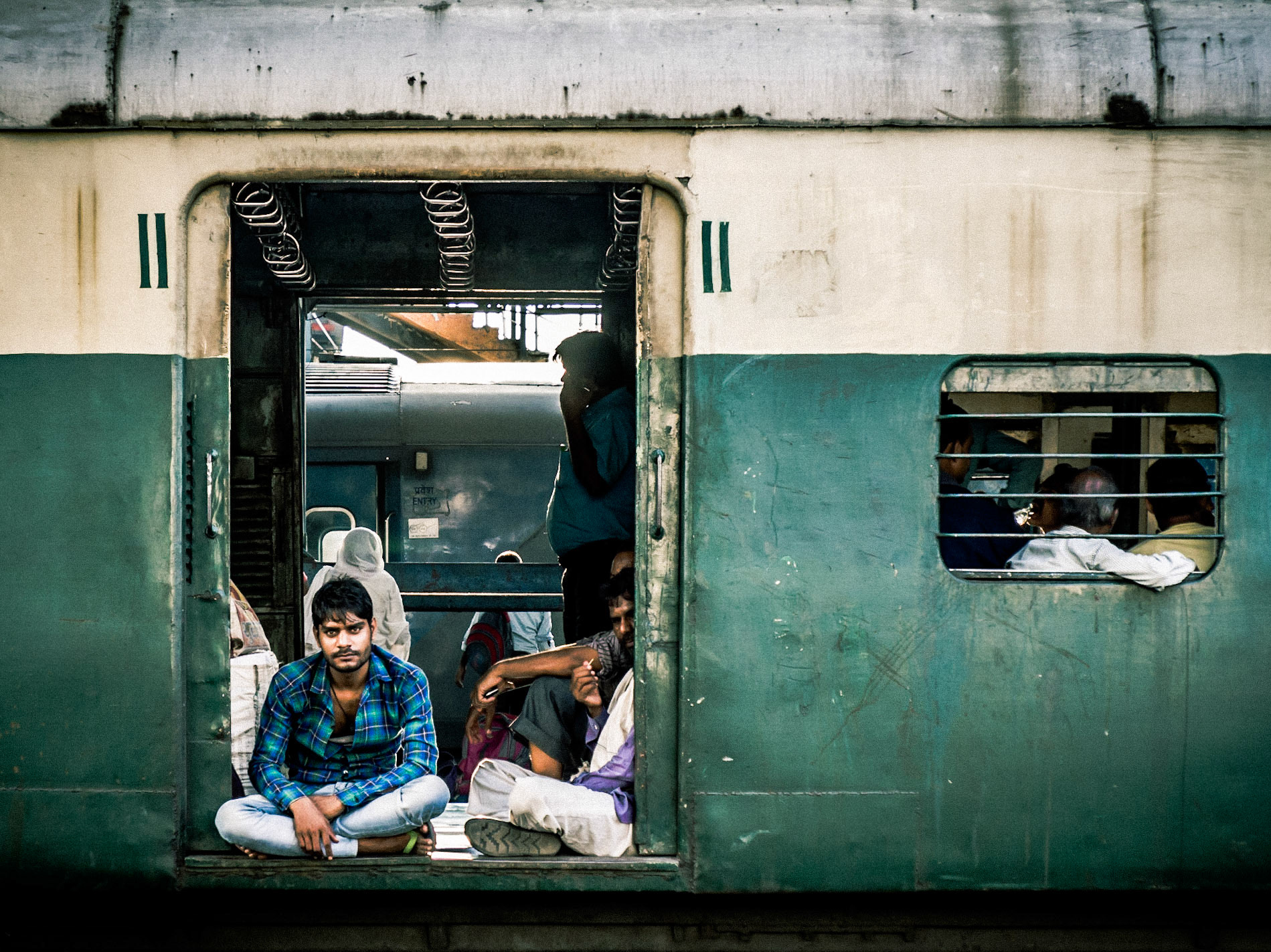 A commuter relaxes as he  awaits the departure of his train at New Delhi Station
