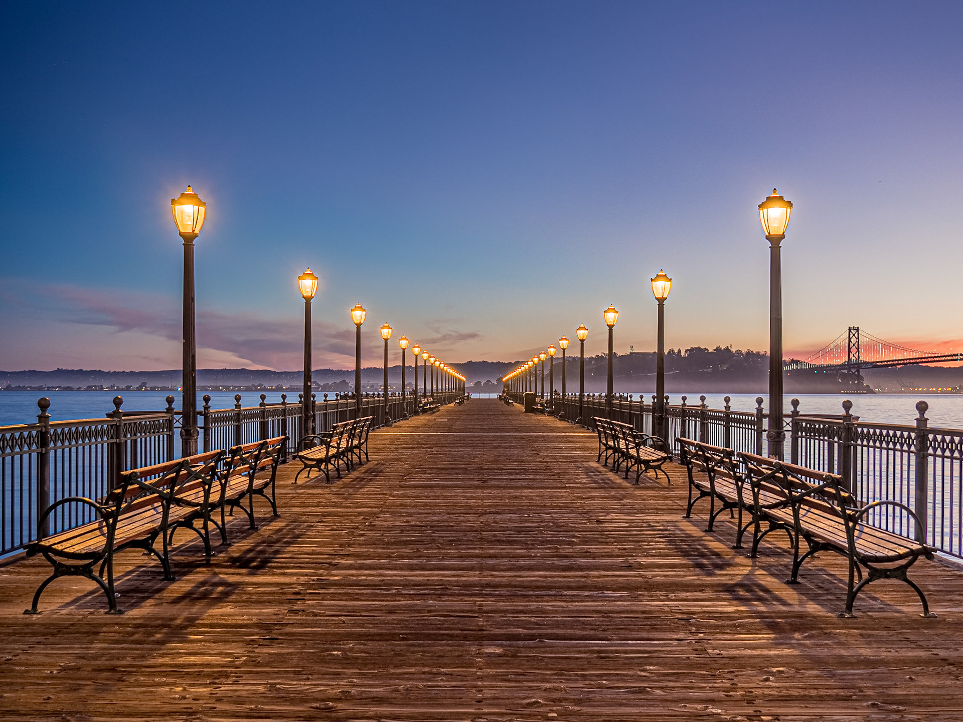 Worn boards form Pier 7 which stretches out into San Francisco Bay next to the Bay Bridge