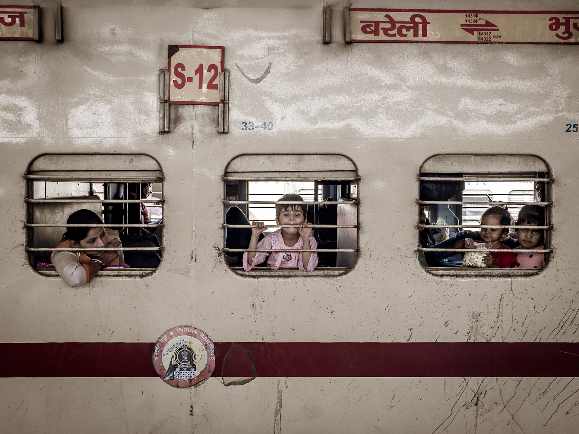 A boy is bored as he waits for his family's train to depart from Old Delhi railway station