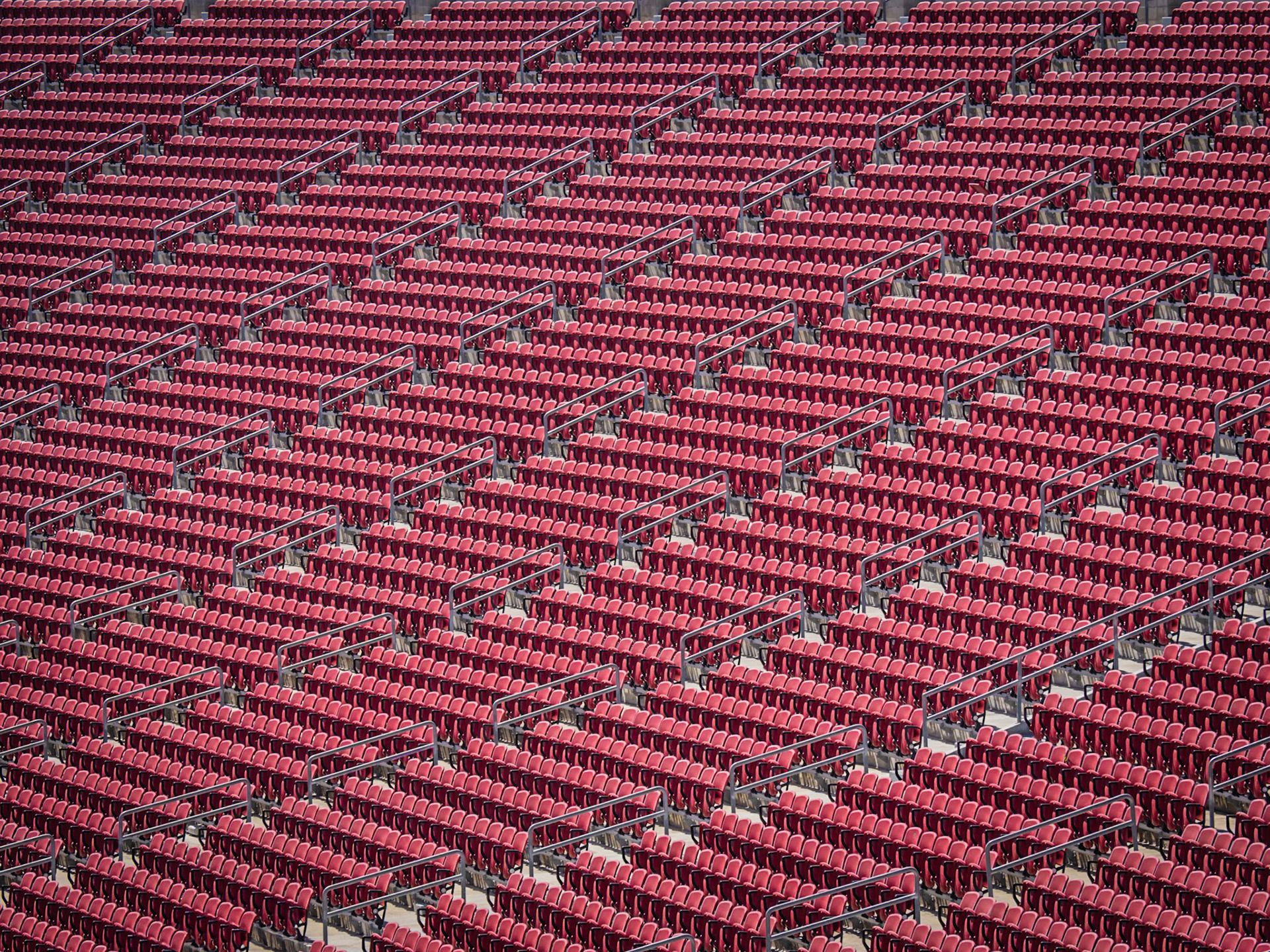 Rows of empty seats line the sides of the Los Angeles Memorial Coliseum