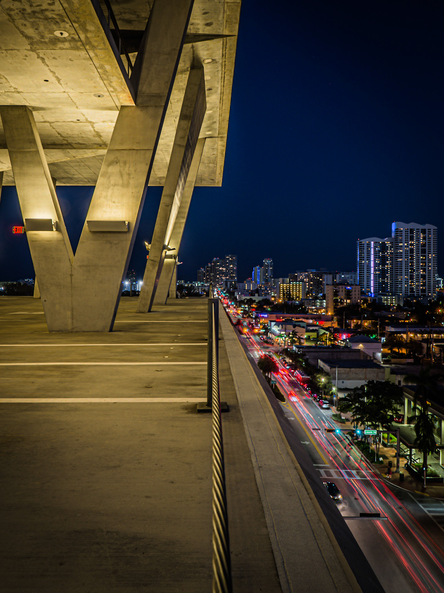 Traffic from the evening rush hour forms light-trails down below a car park in the South Beach district of Miami