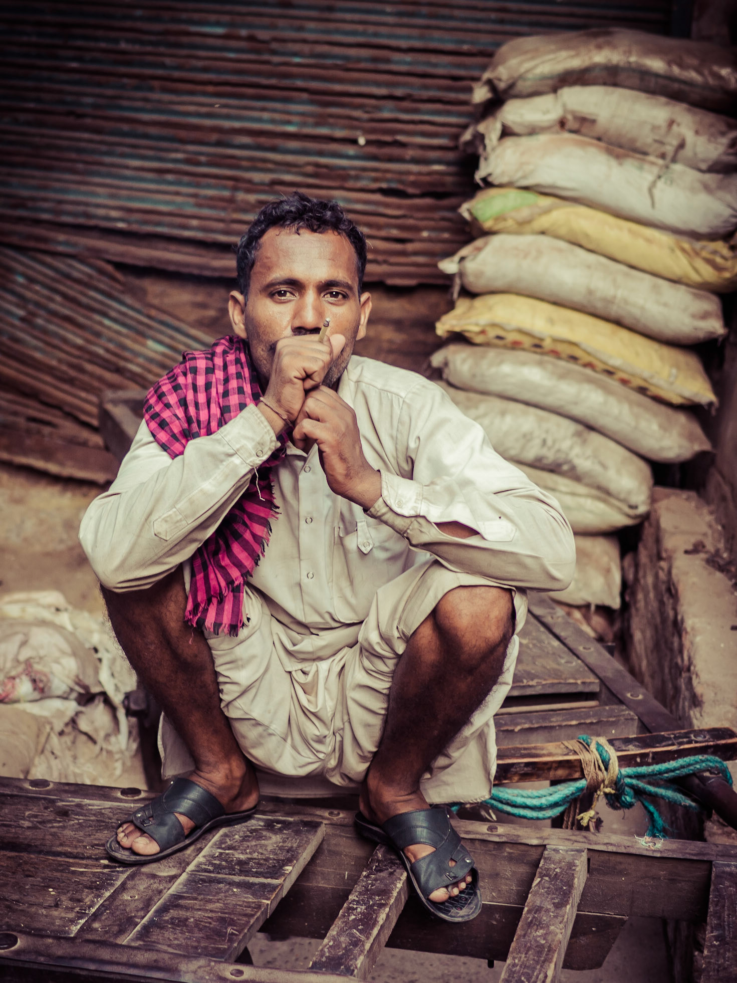 A porter contemplates after a day's work in the spice market at Chandni Chowk in New Delhi