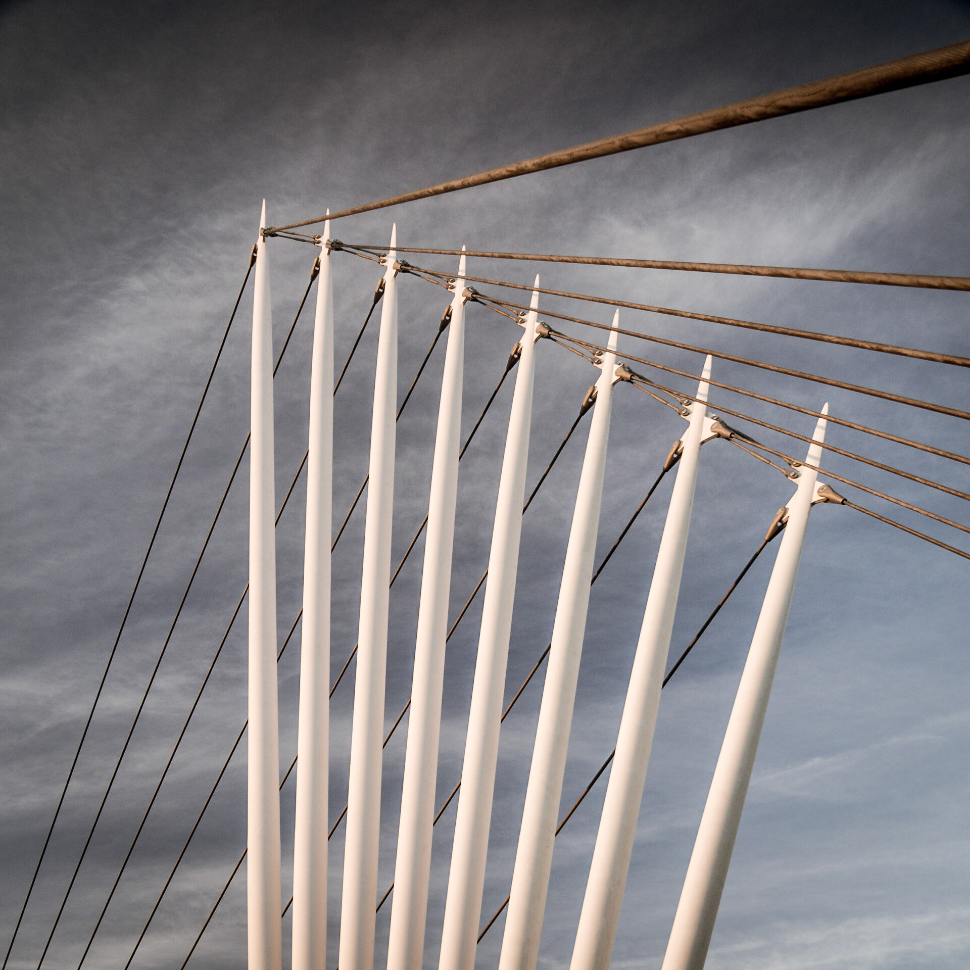 Adjacent columns support the cables of a pedestrian bridge in Salford, Manchester