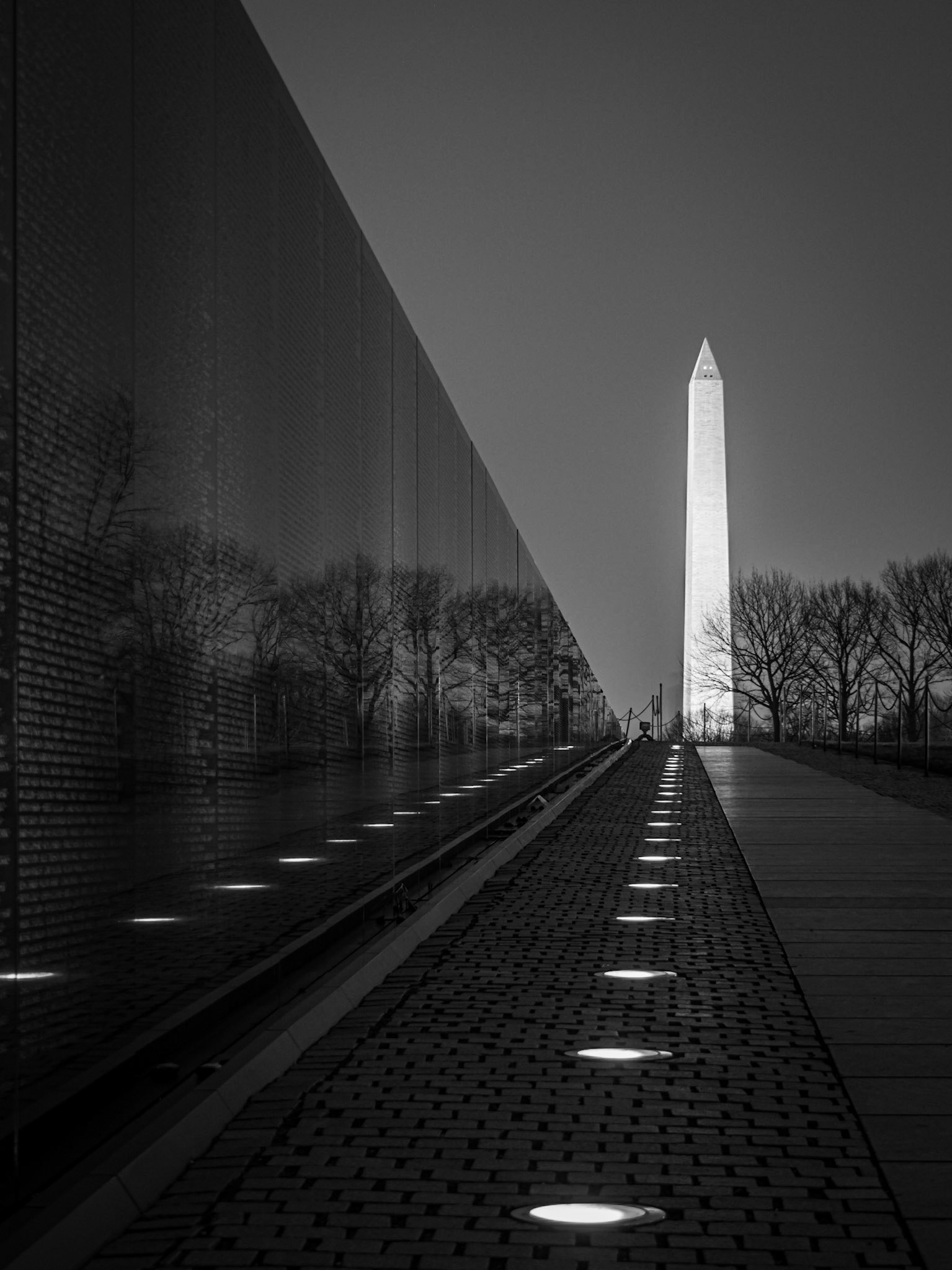 The Washington Monument sits in the background of the Vietnam War Memorial in Washington DC