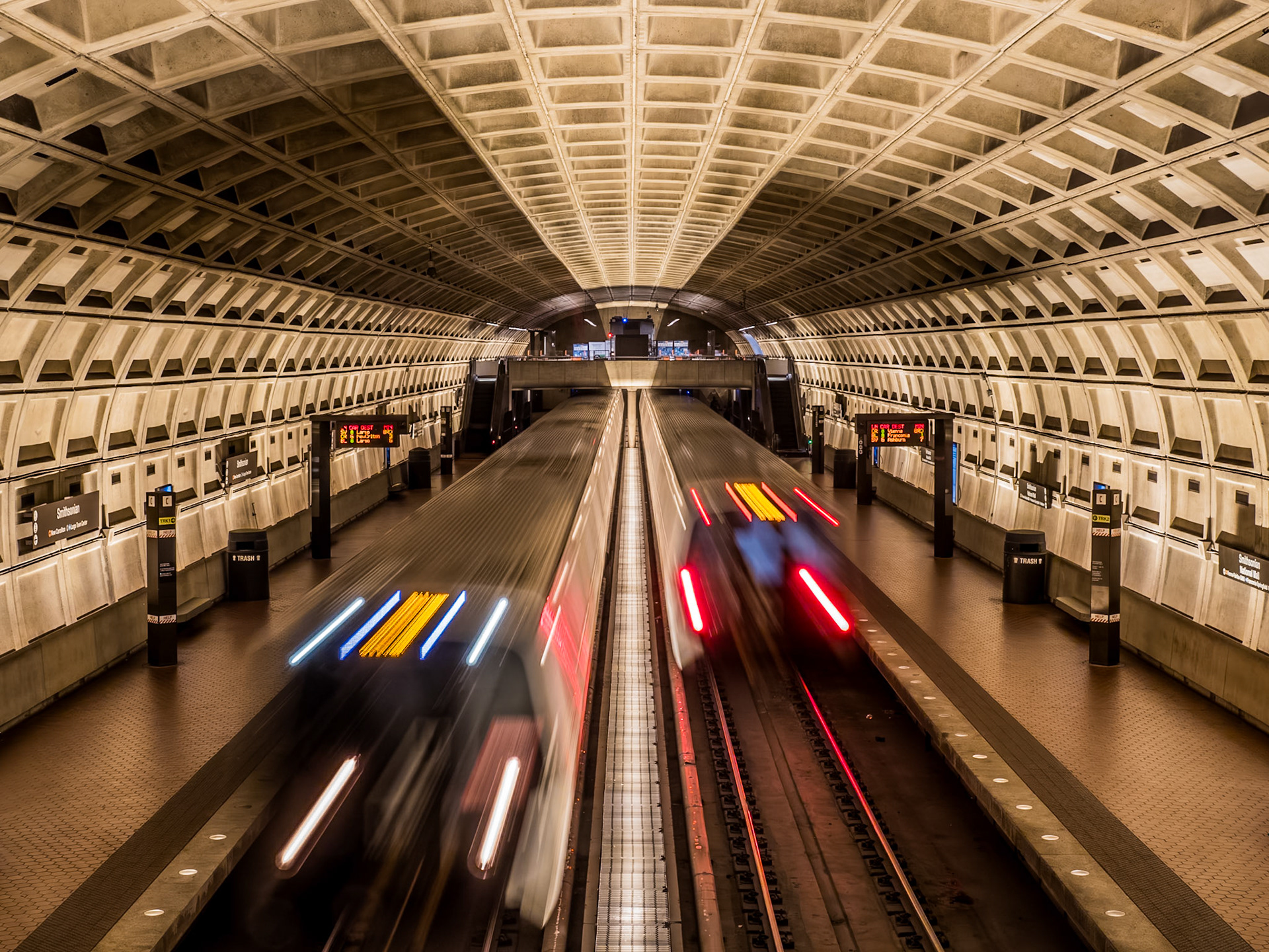 Two metro trains pass eachother during rush hour on the Washington DC metro