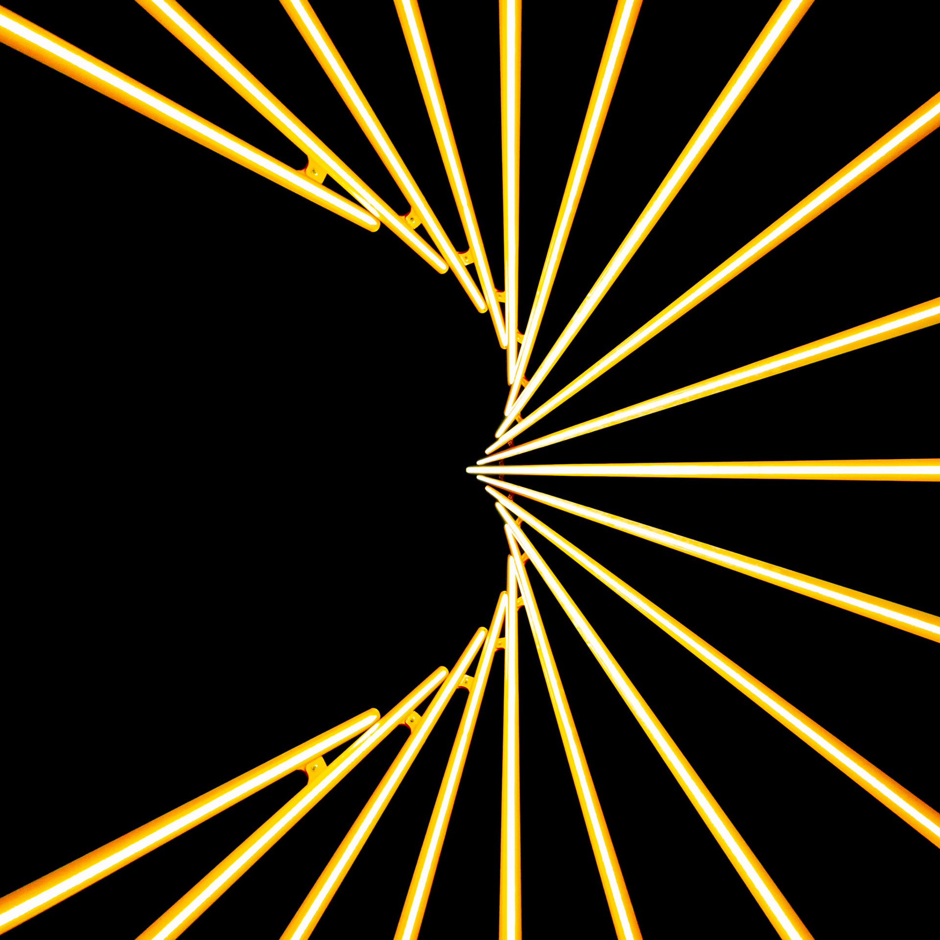 Bright rod s of yellow light converge into the darkness