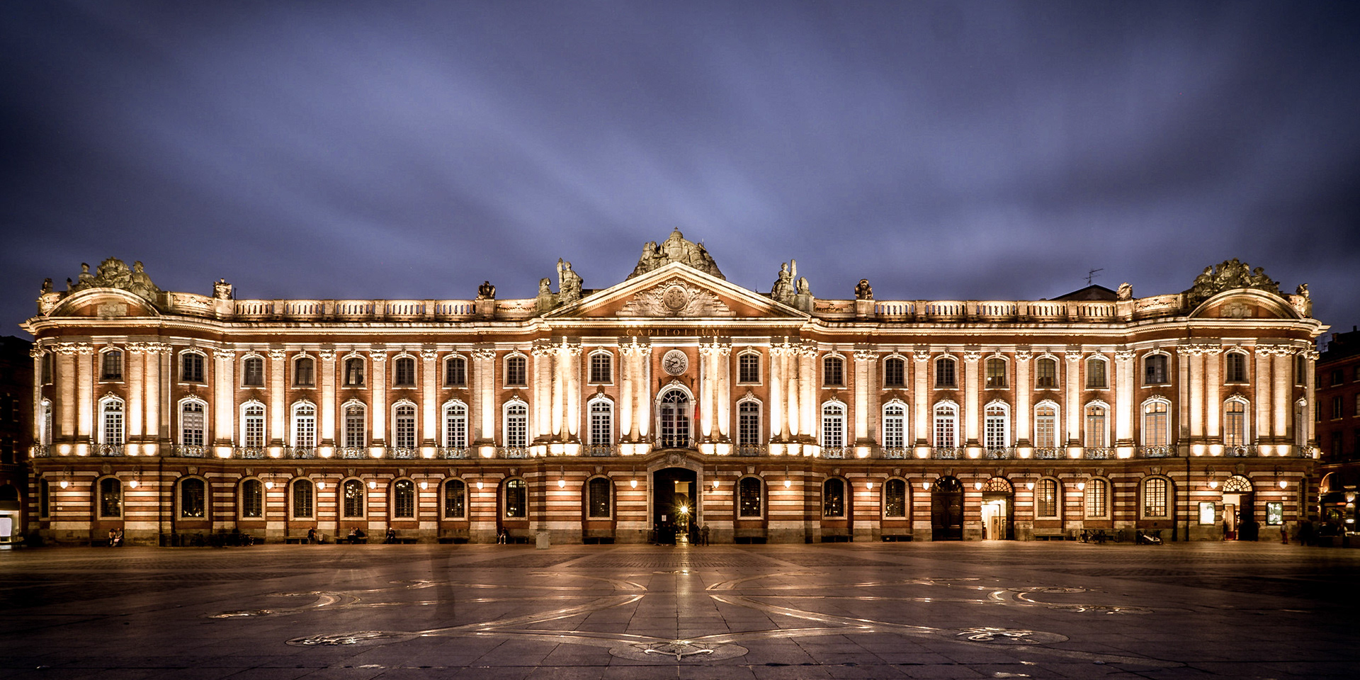 Moody clouds pass above the stunning Capitolium as dusk falls in Toulouse