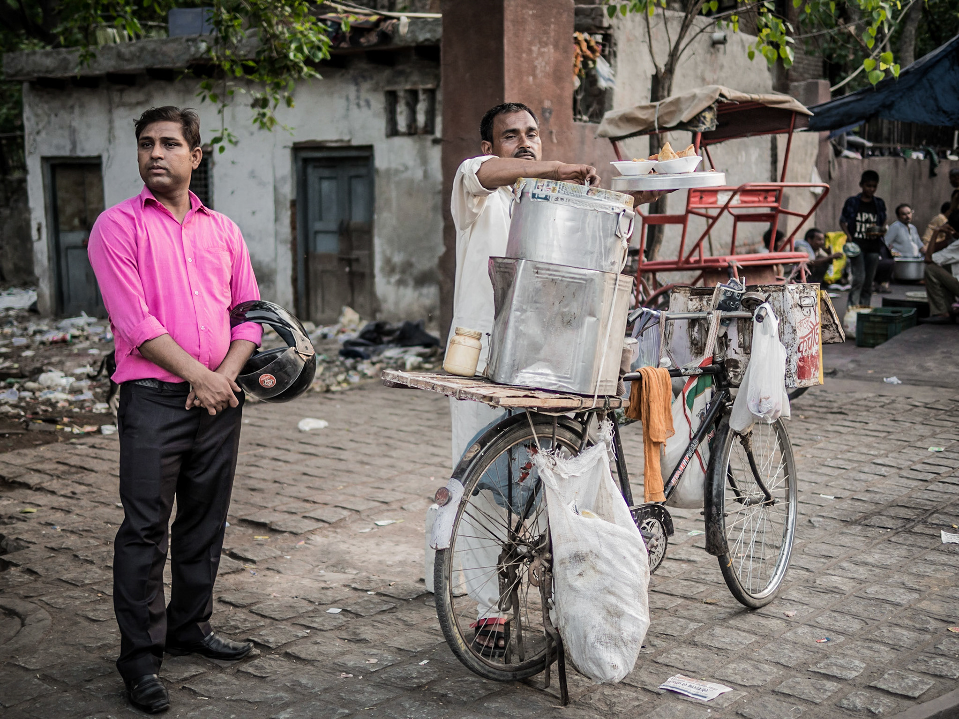 A customer avoids watching a street-seller prepare his food in the Chandni Chowk market district of New Delhi