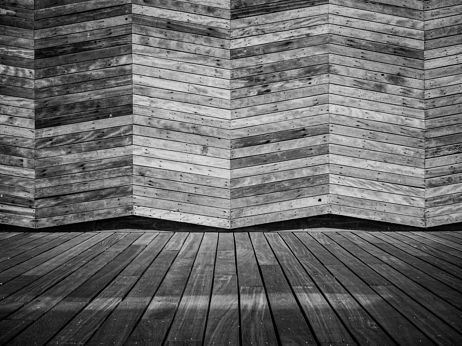 Angled planks form the backdrop to the modern boardwalk of Hastings Pier, Sussex