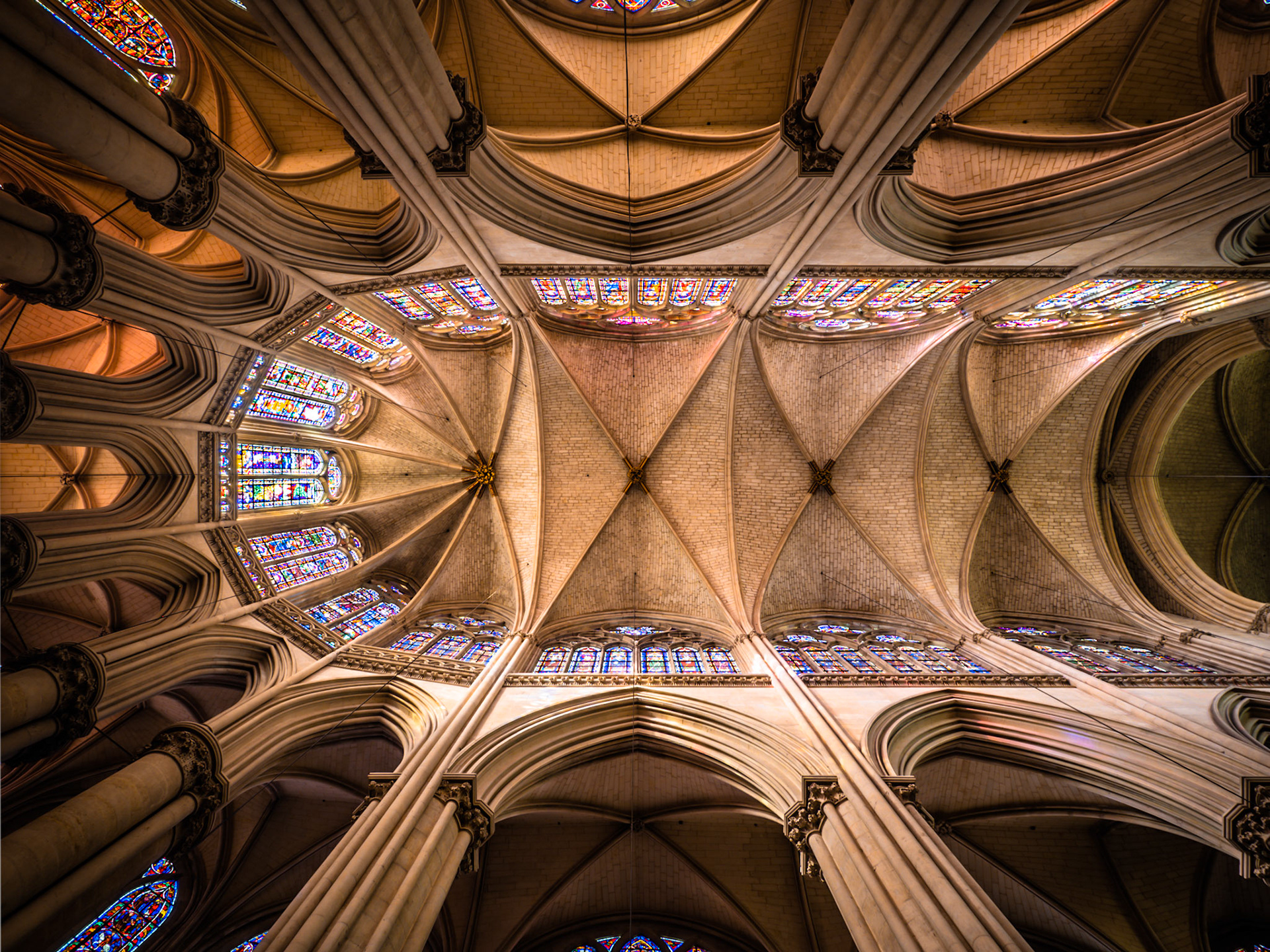 The lofty vaulted ceiling with beautiful stained glass windows of the Cathederal Saint Julien in Le Mans