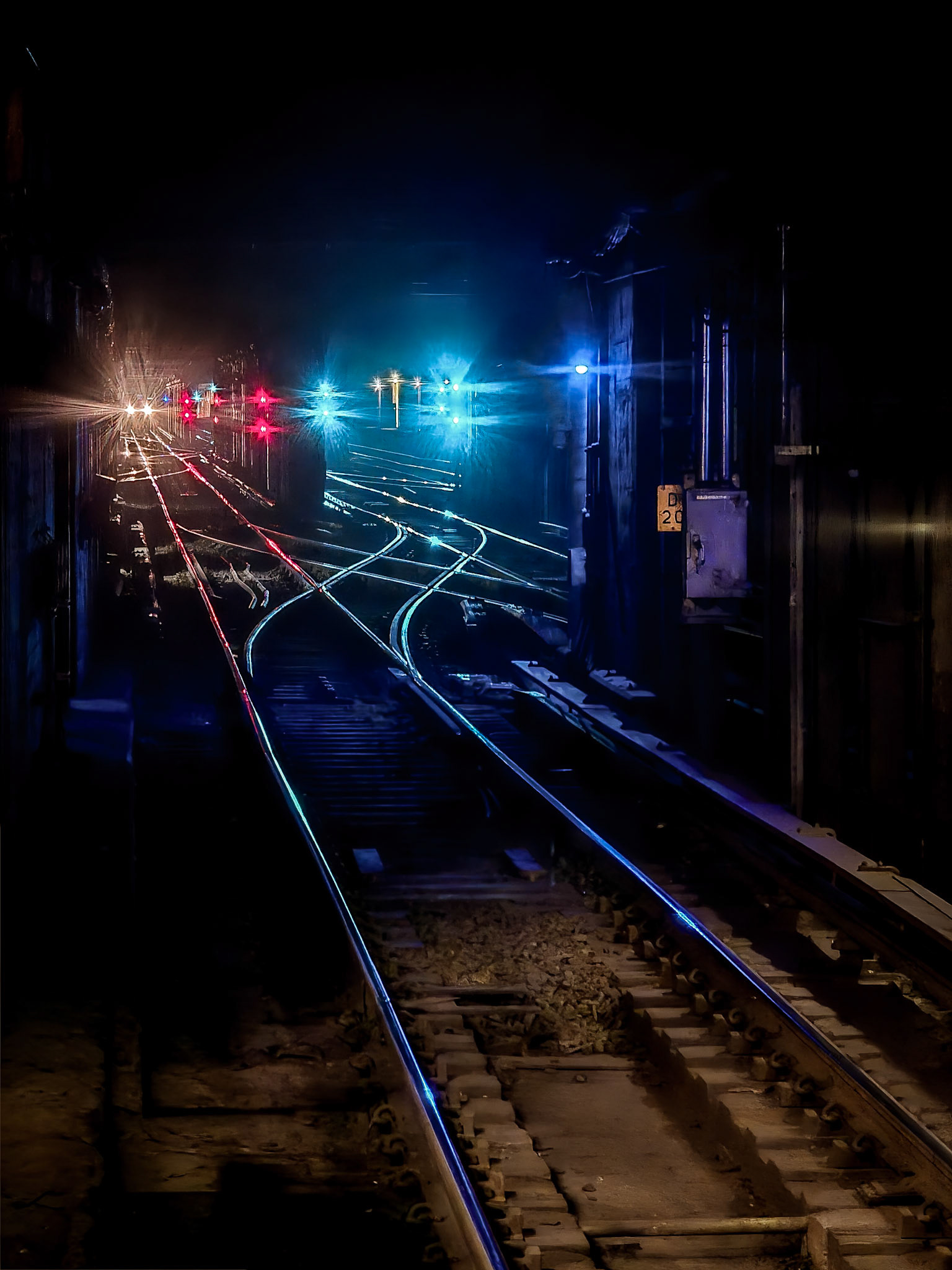 LIghts reflects off the shiny rails of New York's subway