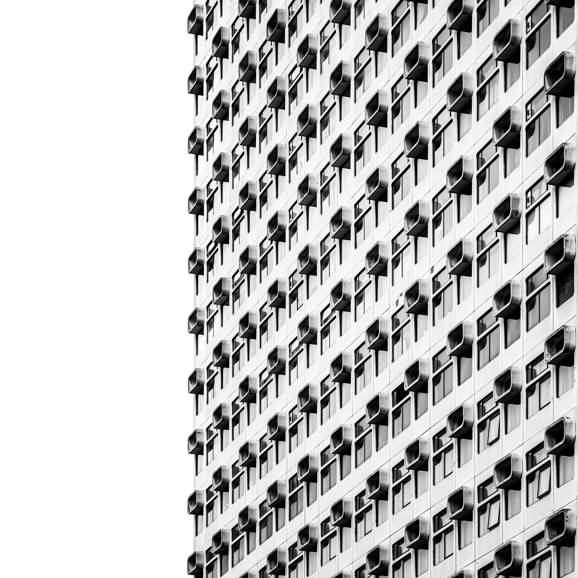 Unusual windows fittings jut out into the skyline from a block of apartments in Manchester