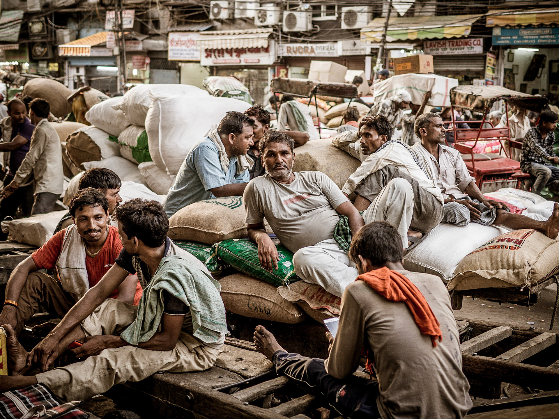 Porters chat over the day's events after finishing their work in the Chandni Chowk district of New Delhi