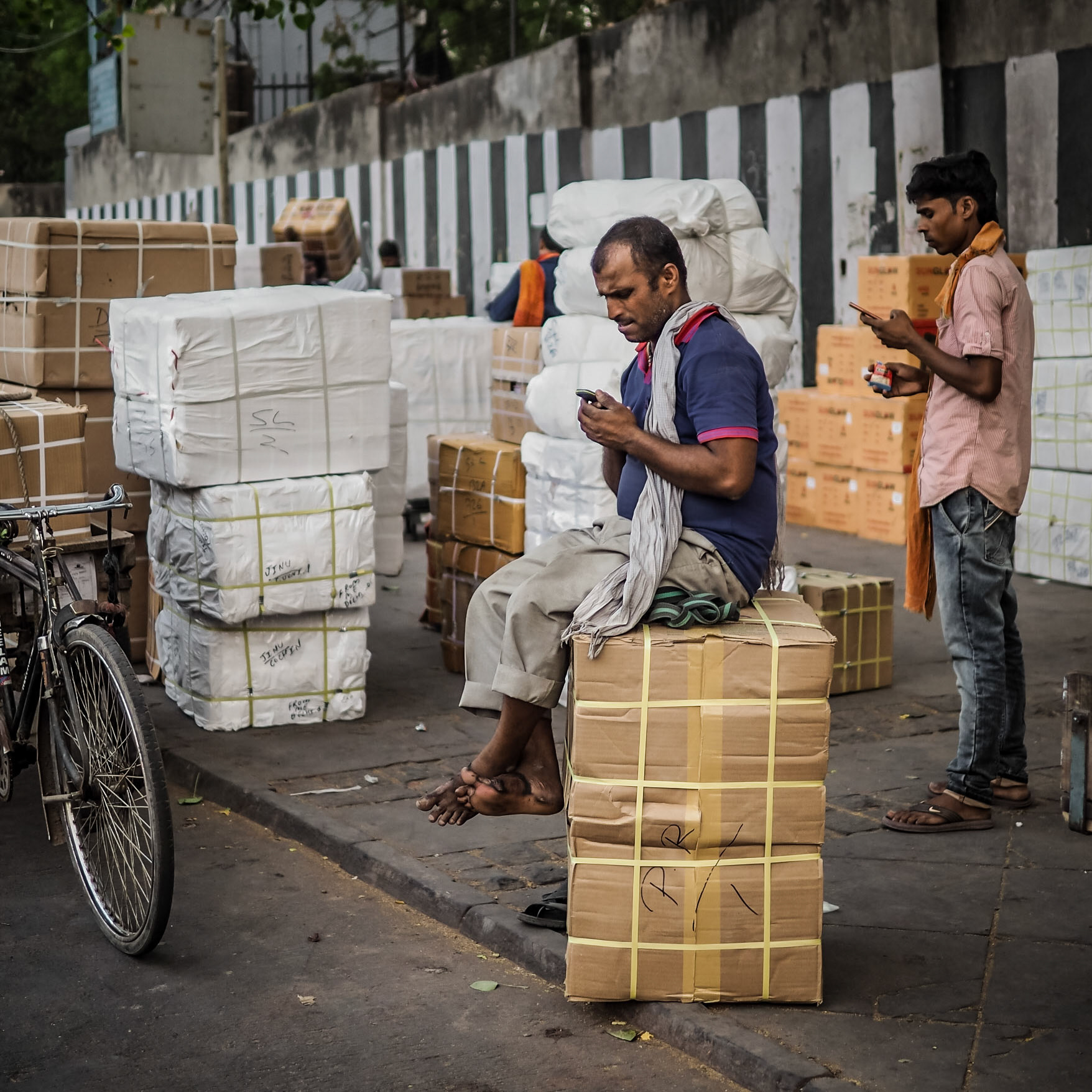 Porters check their latest messages  in the Chandni Chowk market district of New Delhi