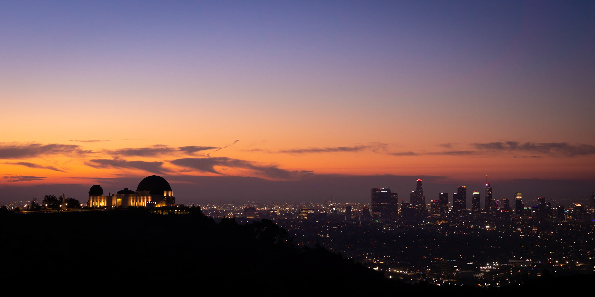 The iconic Griffith Observatory looks over downtown Los Angeles as dawn rises