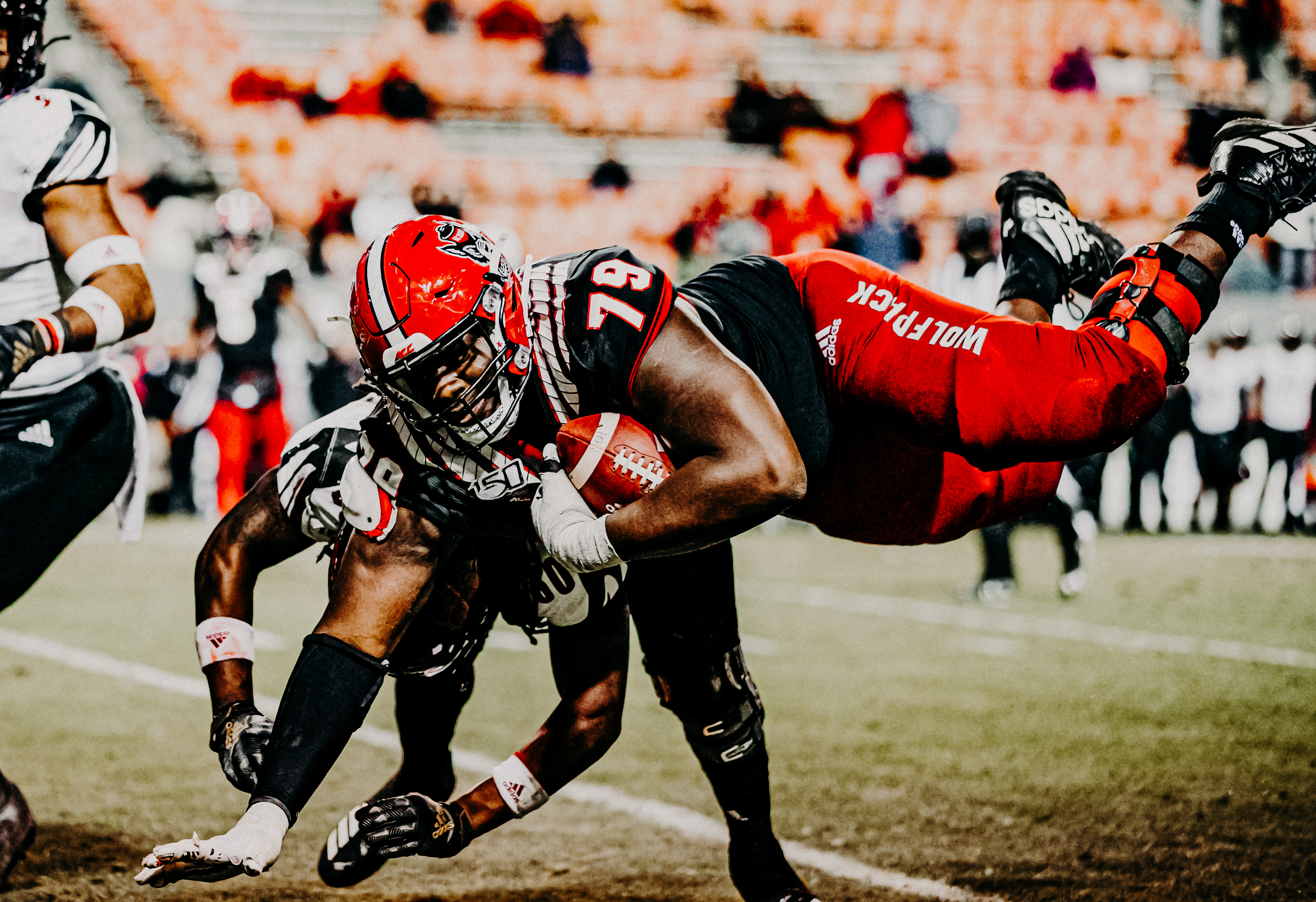 Offensive lineman Ikem Ekwonu dives forward after picking up a fumble against Louisville on Nov. 16, 2019.