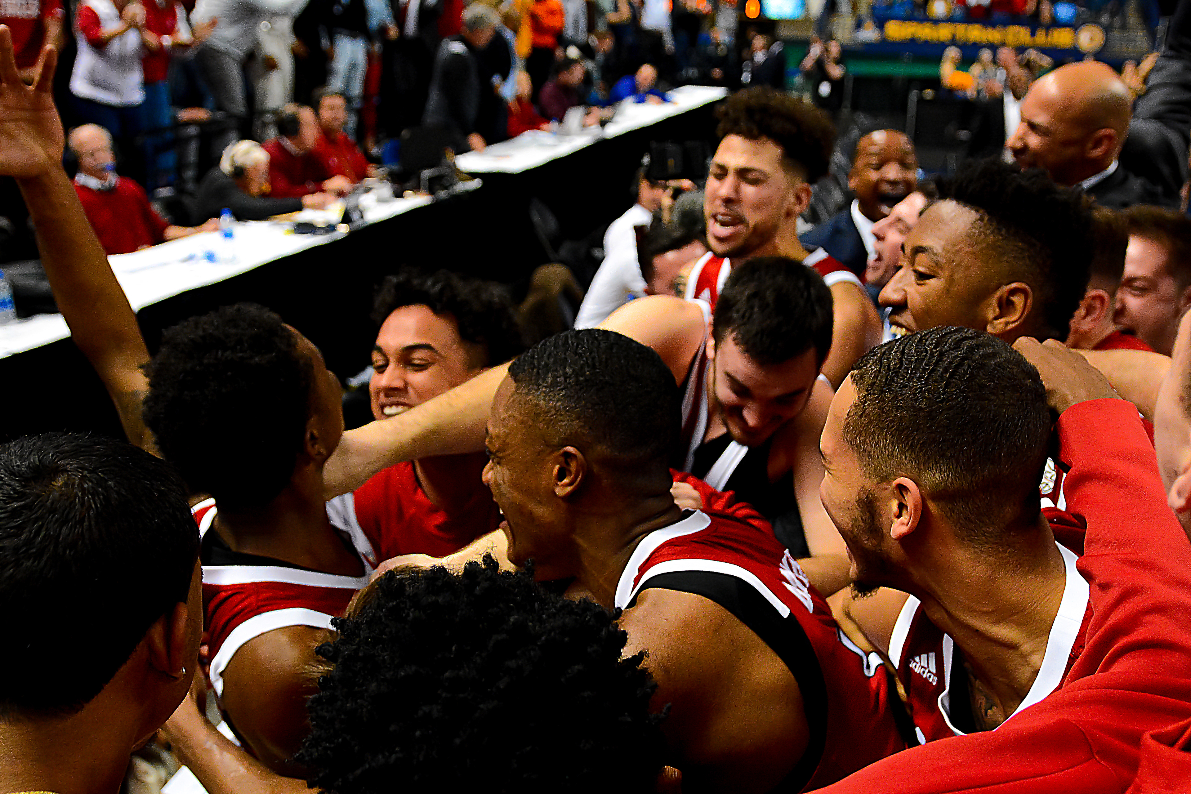 Markell Johnson raises his arm to celebrate his half-court buzzer-beater to beat UNC Greensboro on Dec. 15, 2019.