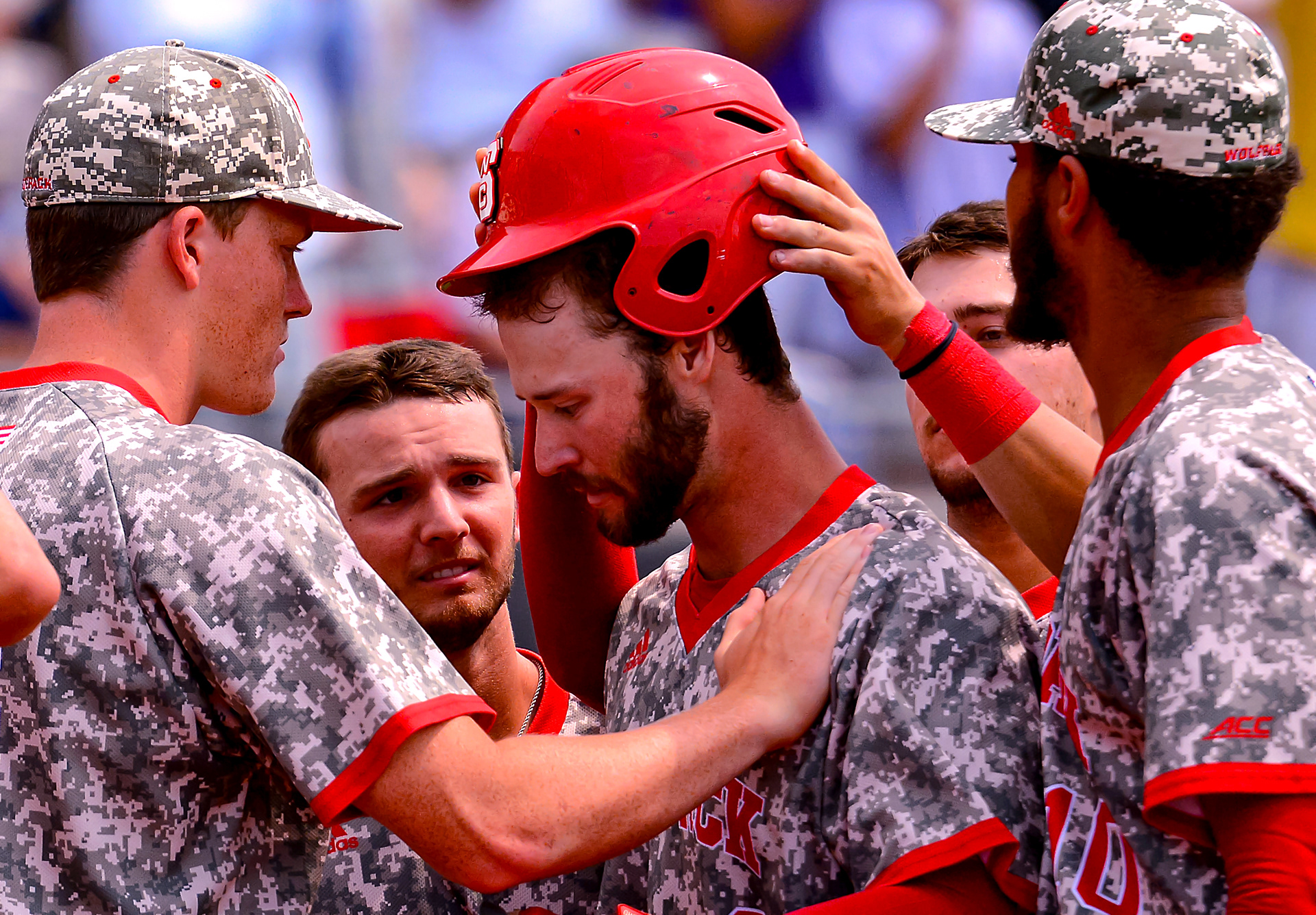 Teammates embrace senior Evan Edwards after homering in his final Wolfpack at-bat on June 2, 2019. 