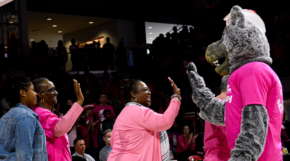 Mr. Wuf high-fives cancer survivors at halftime of the Play4Kay game on Feb. 18, 2018.