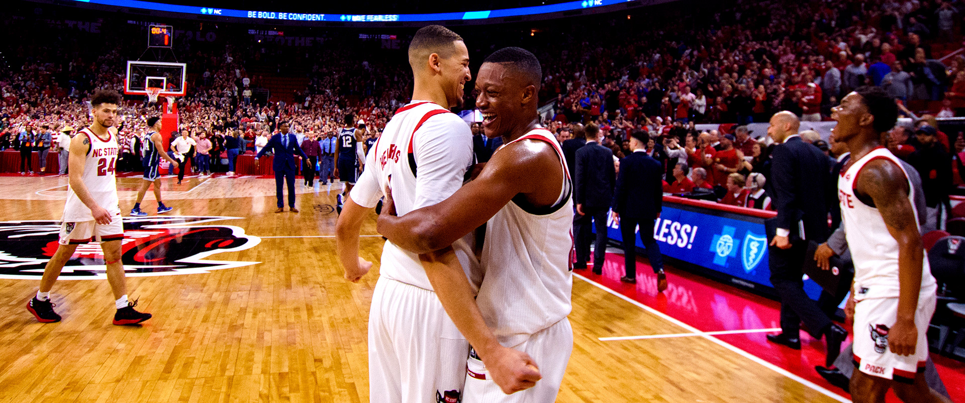 Sophomore Jericole Hellems (left) and senior C.J. Bryce (right) embrace as the game ends.