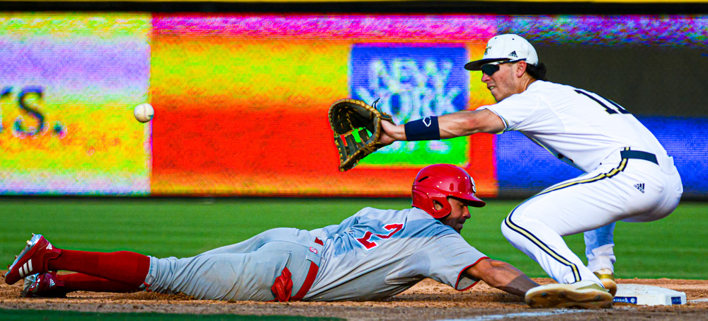 Jonny Butler dives back safely under the tag of Georgia Tech's Tristin English on May 25, 2019.