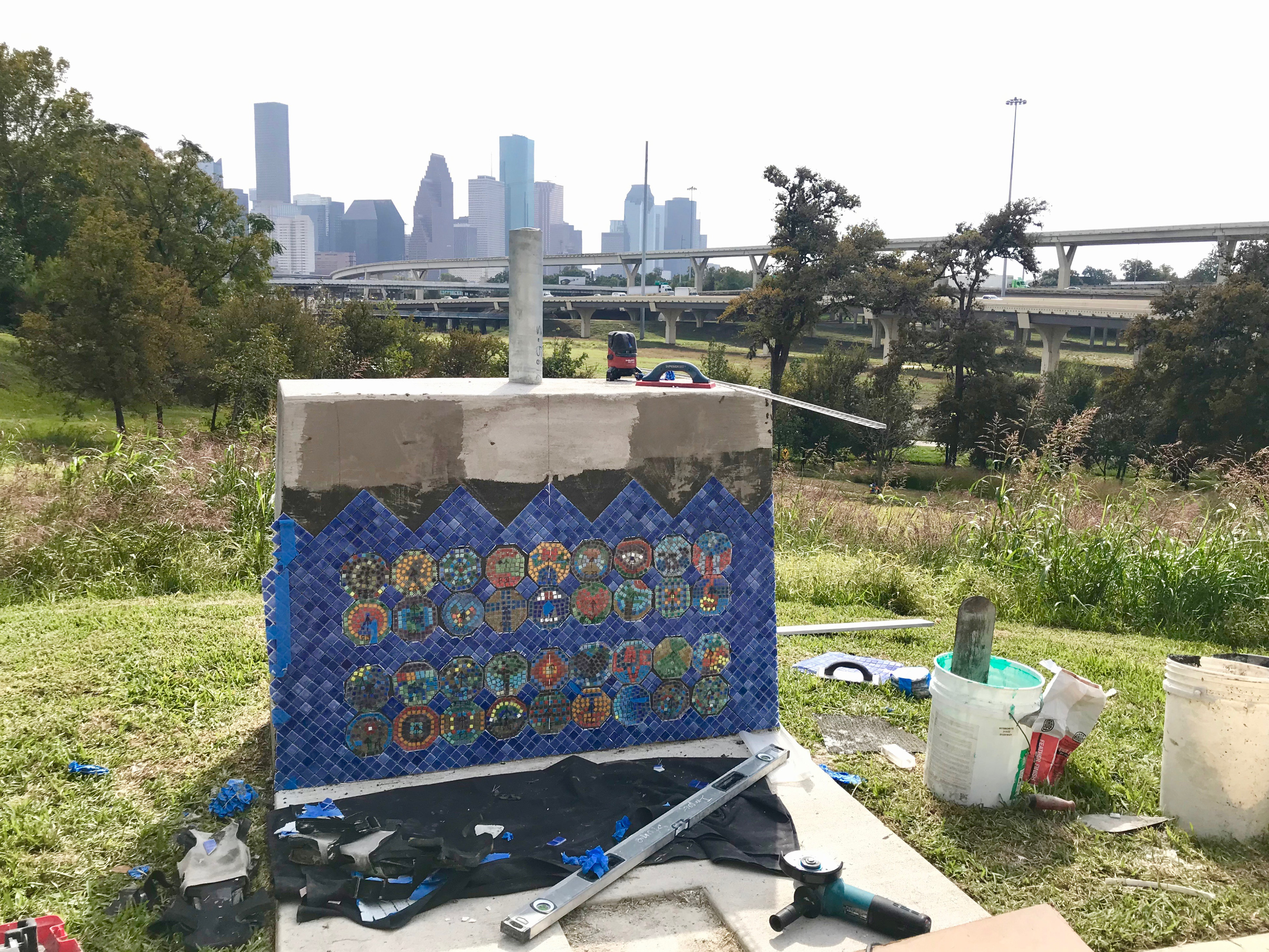 Impact Stone Installing mosaic tile florets created by the community