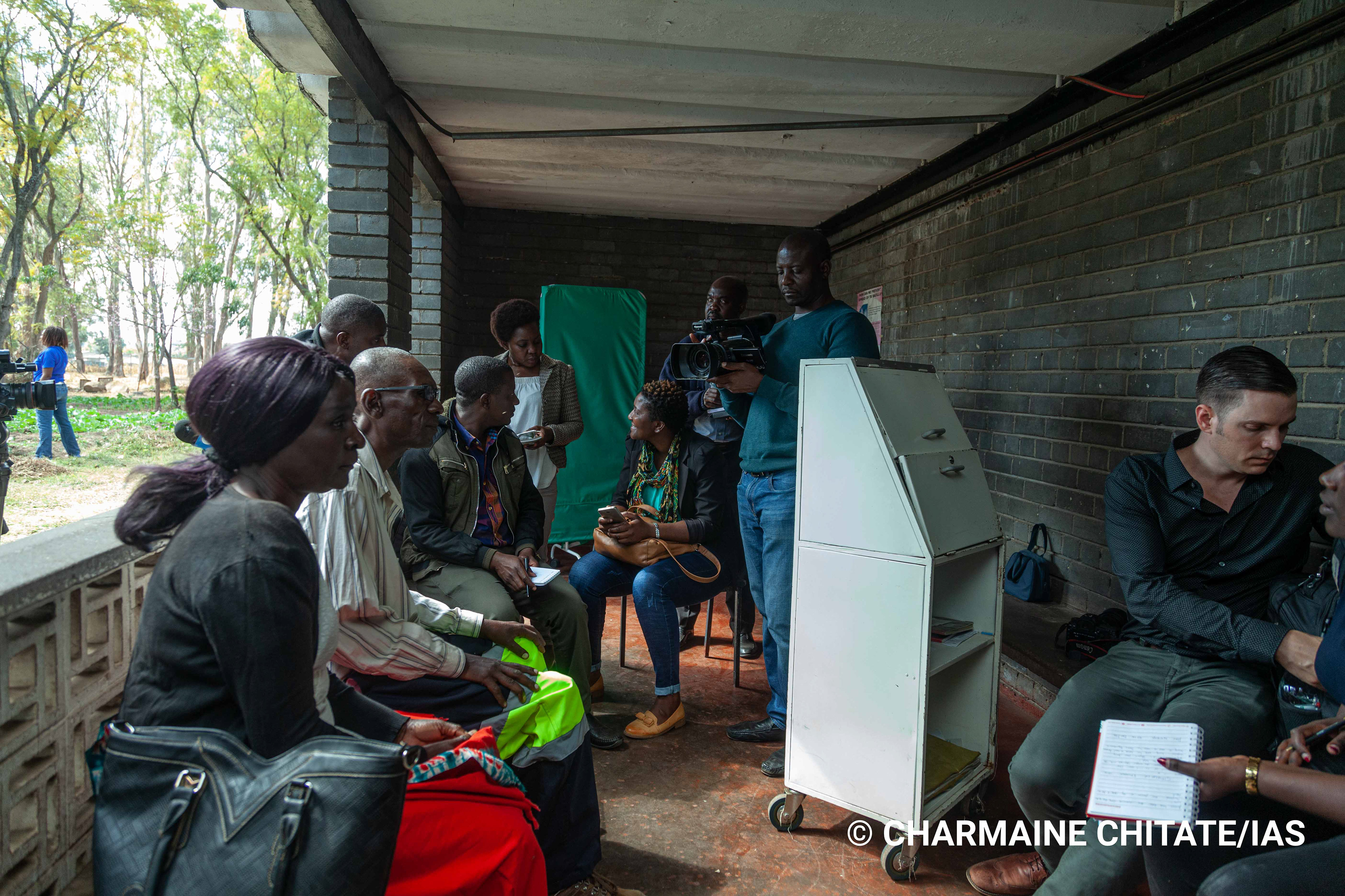 Journalists preparing to interview a patient at Rutsanana Polyclinic as part of a Media Field Trip facilitated by the International AIDS Society (IAS). (Photographer: Charmaine Chitate/IAS)