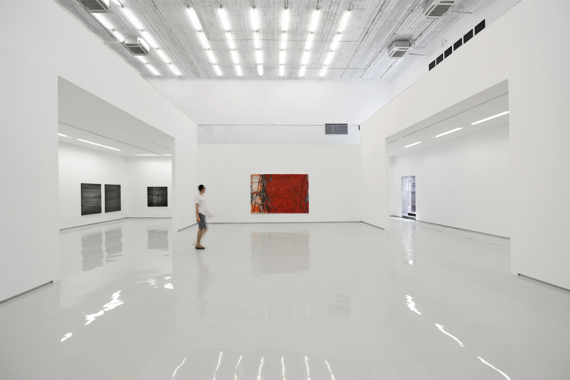 PIFO New Art Gallery / archstudio - Beijing China. Highly reflective surface contrasts the rougher walls.