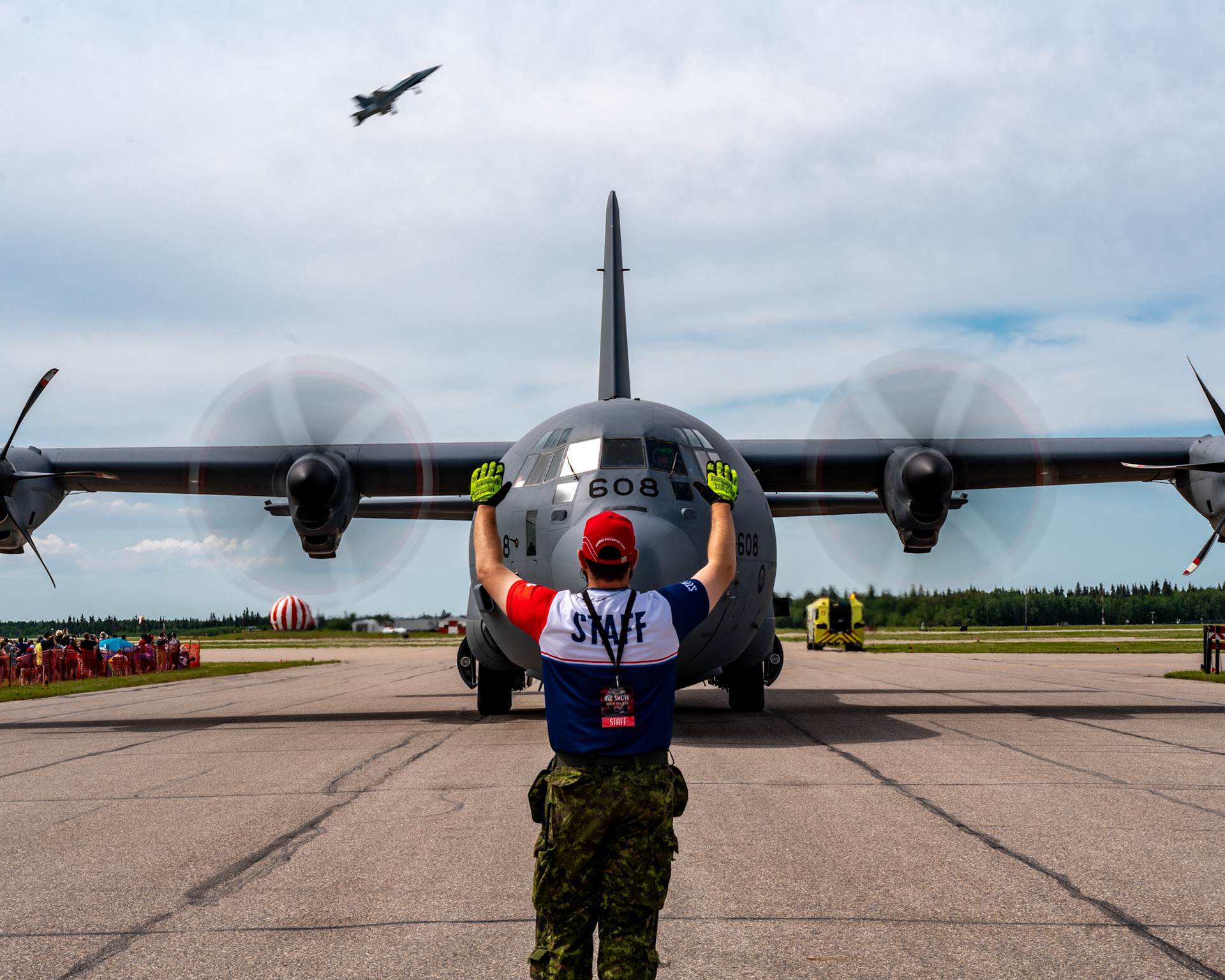 CAF ground crew bring in the CC-130 as Capt Jesse Haggart-Smith takes to the skies in the CF-188