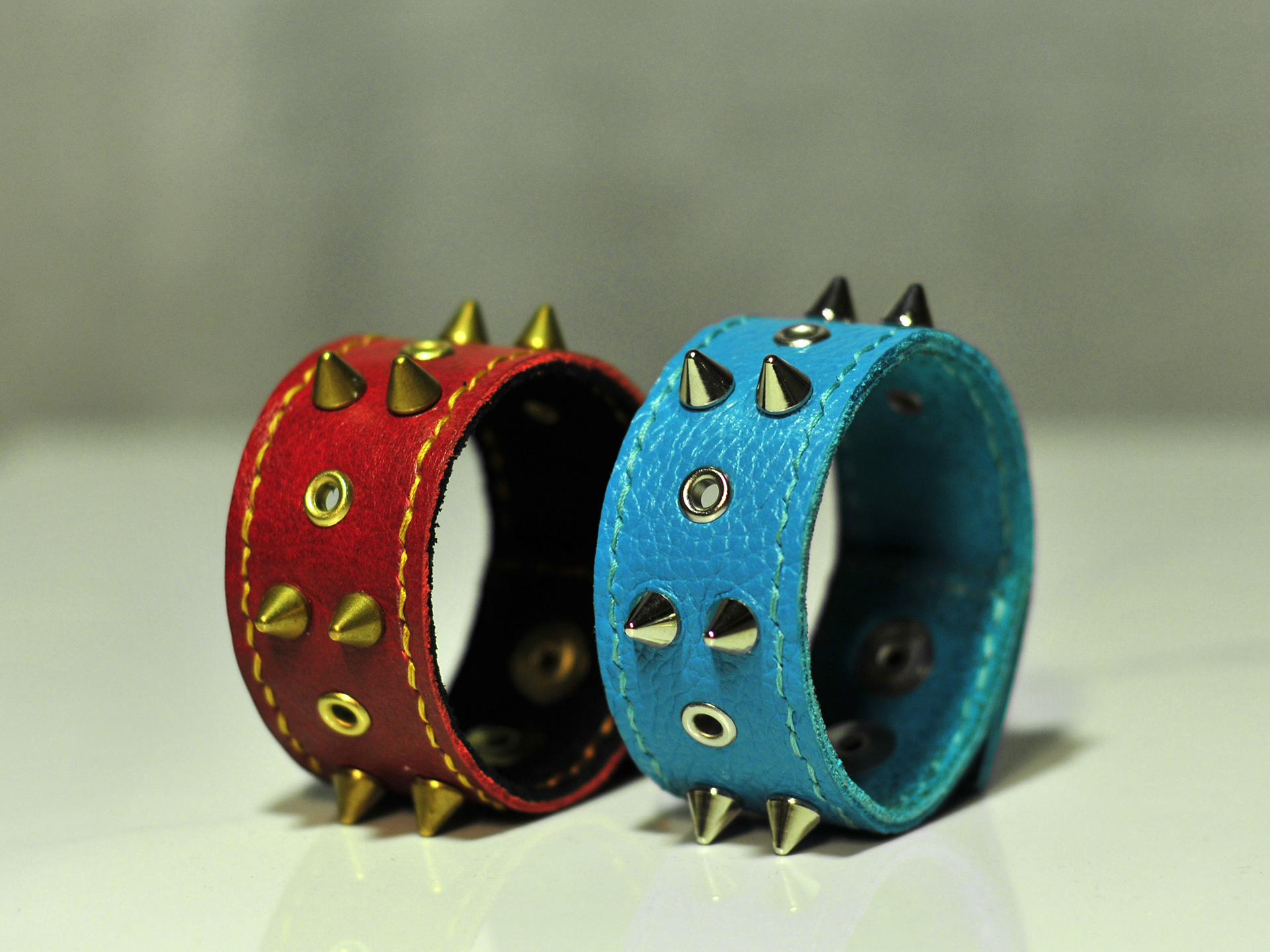 The uniqueness of these bracelets feature a 'hidden' spike aesthetic that allows for better comfort of the wearer without diminishing the overall aesthetic. It features a 2-layered, tightly stitched band with varying leather faces and a 'soft' backing for comfort.