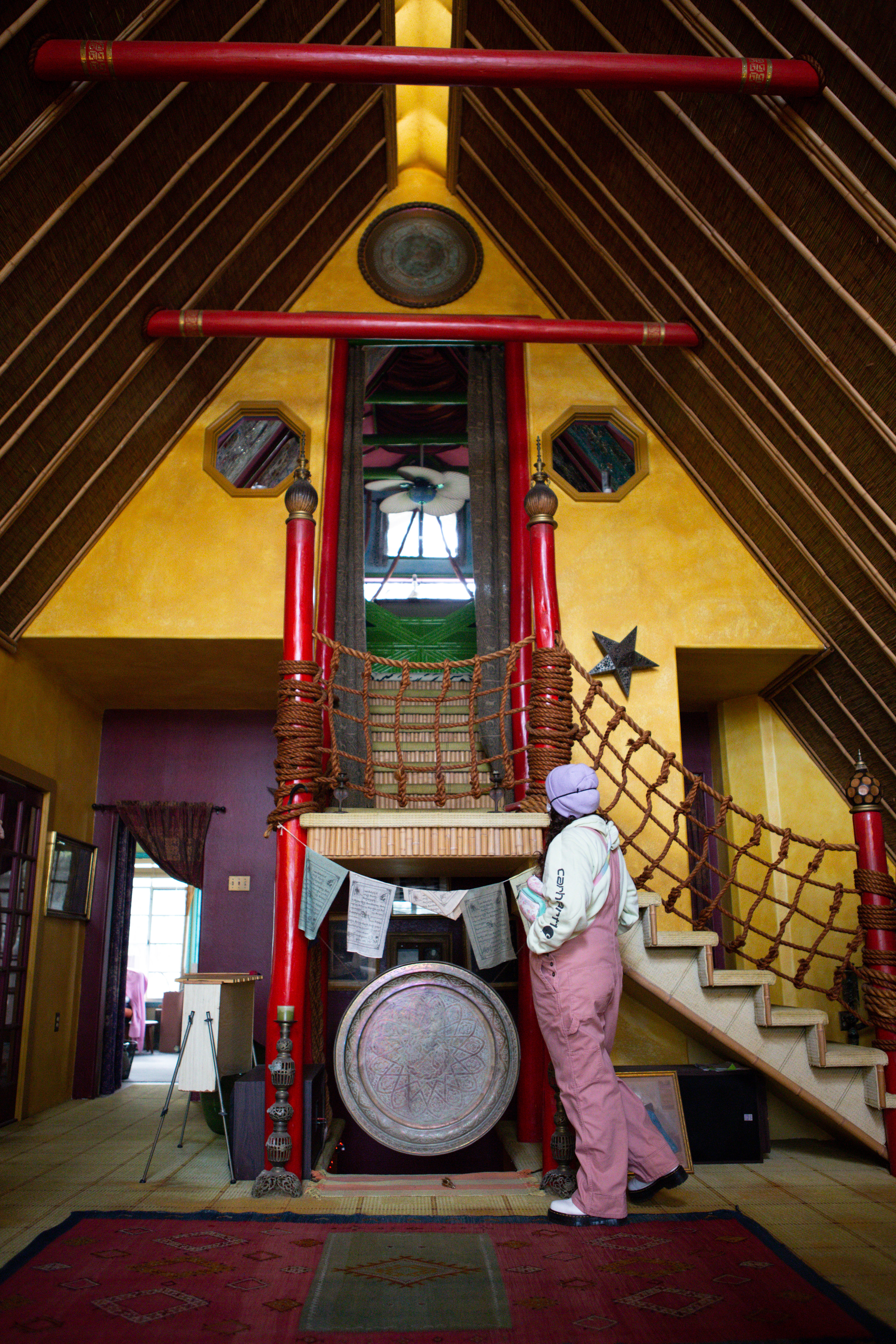 A tour attendee looks at the staircase leading to his third-floor bedroom. Talbot added the “bali-inspired” second and third floors 17 years after moving into the house.