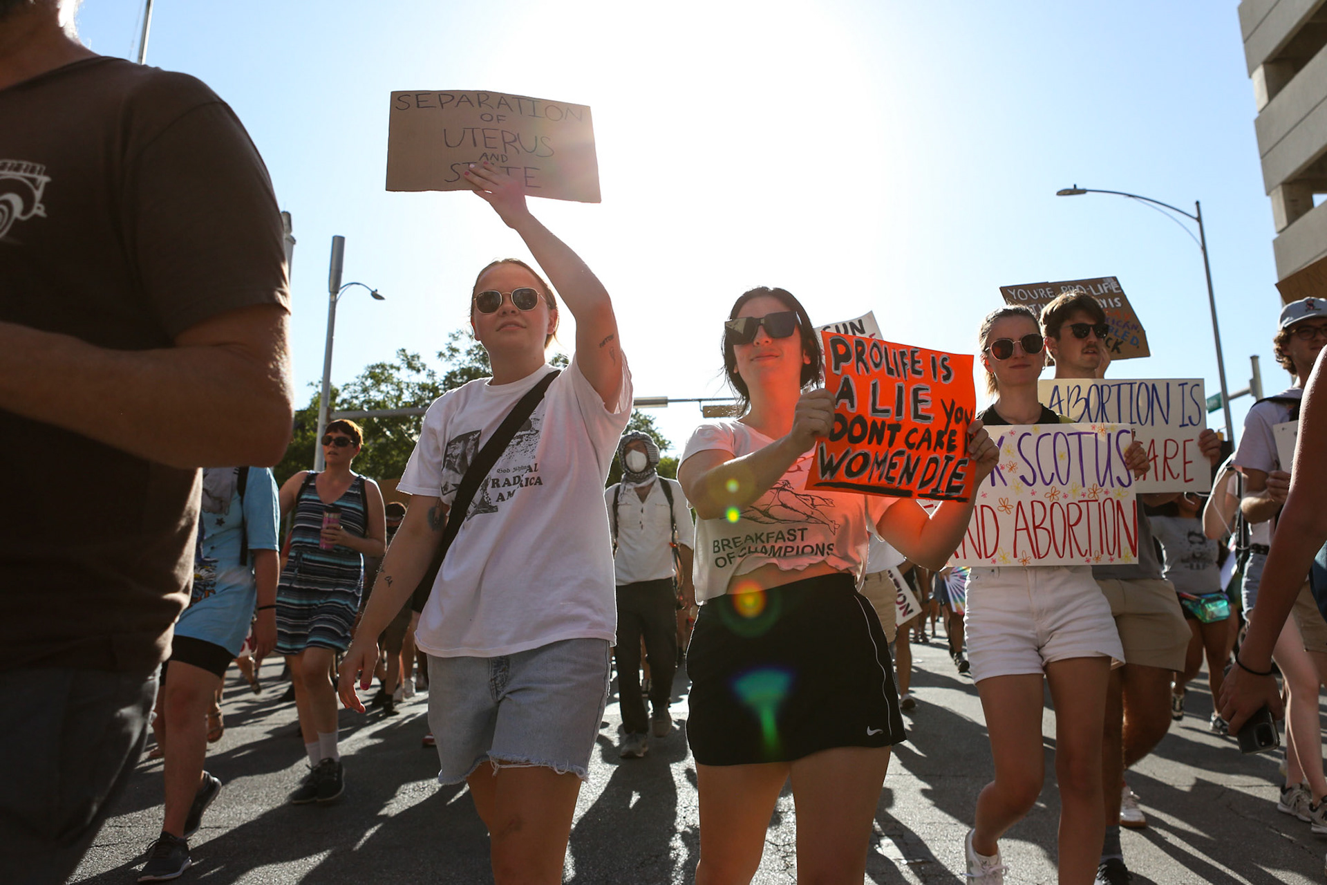 Two women raise their signs in the air on June 24.