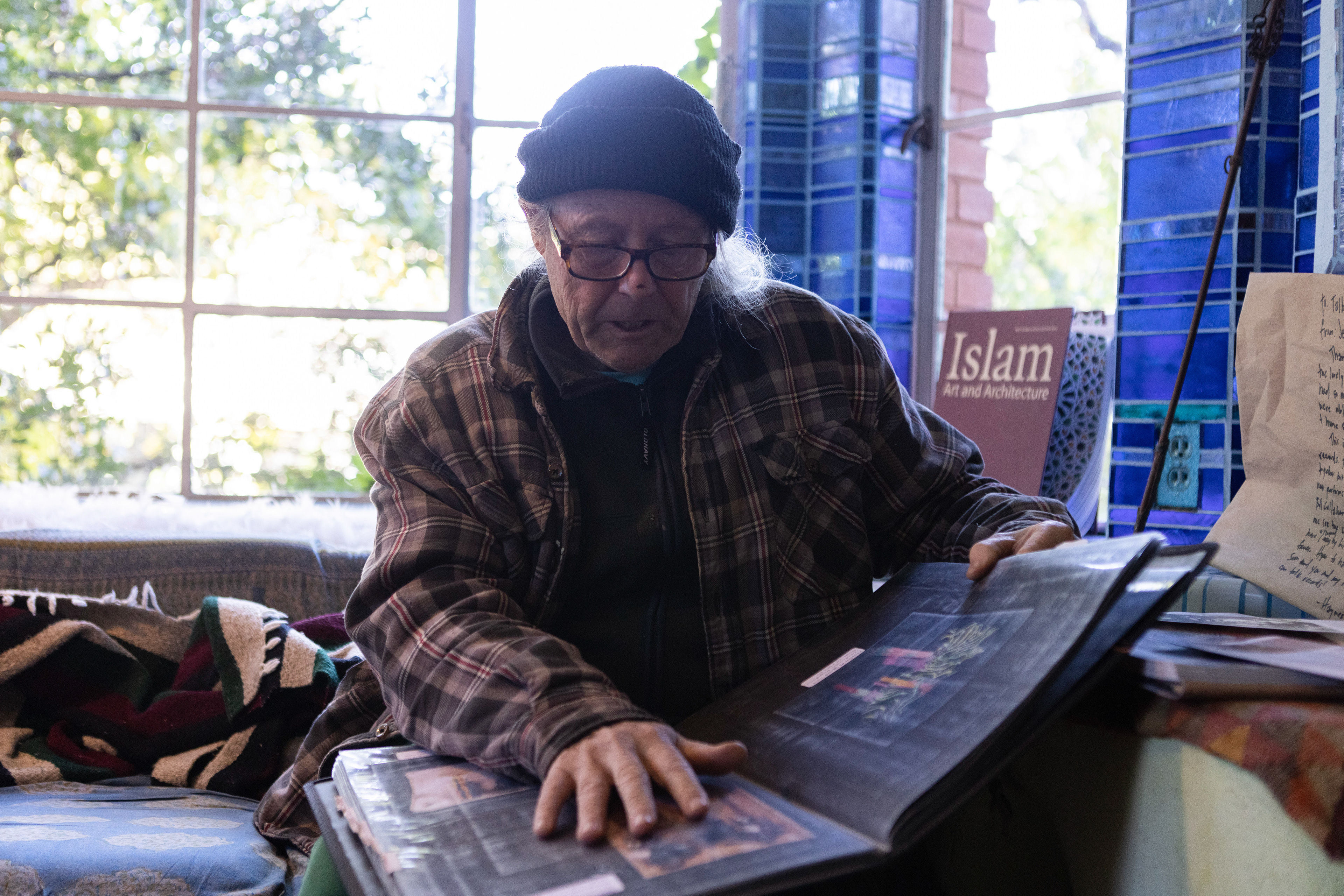 Talbot goes through his portfolio showcasing his past work, which catalogues each piece of art he’s made since the 1970’s.