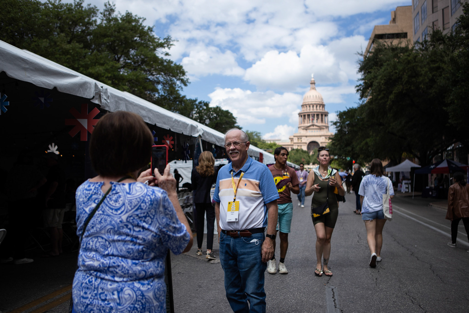 Festival goers pose on Congress Avenue at Texas Tribune Fest in Austin on Sept. 24, 2022.