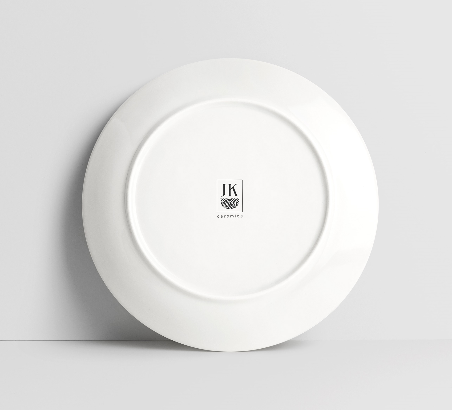 Jenny Kramer Ceramics logo design envisioned painted on bottom of a ceramic plate